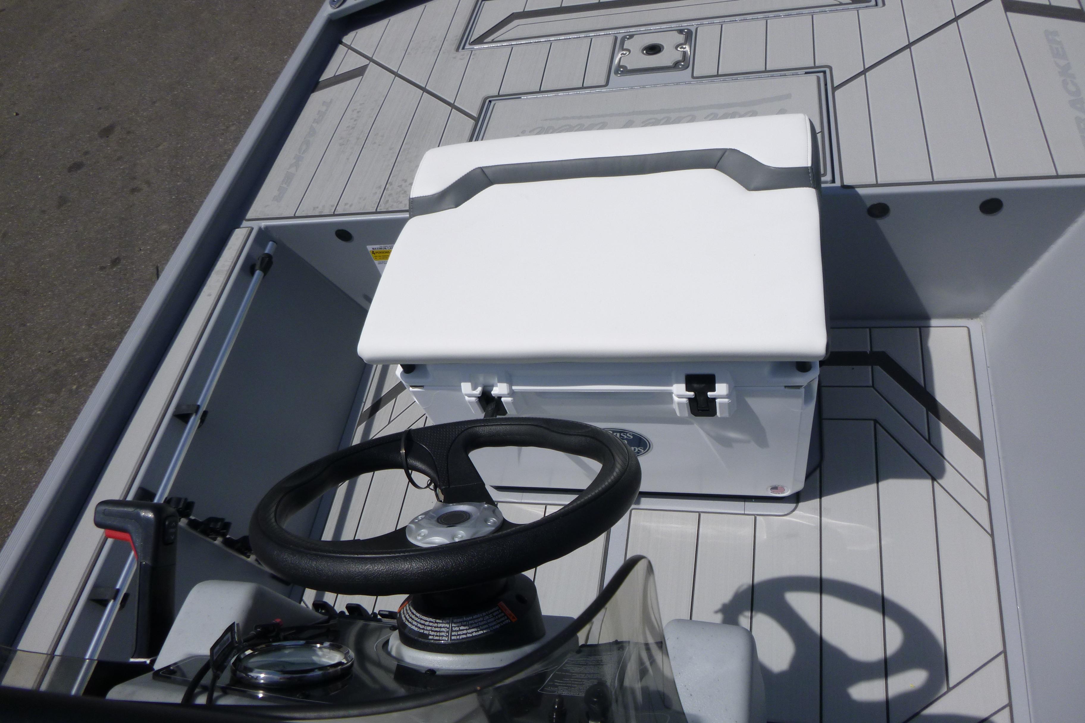 2026 Tracker Bass Tracker Classic CC boat interior with steering wheel and storage compartment.