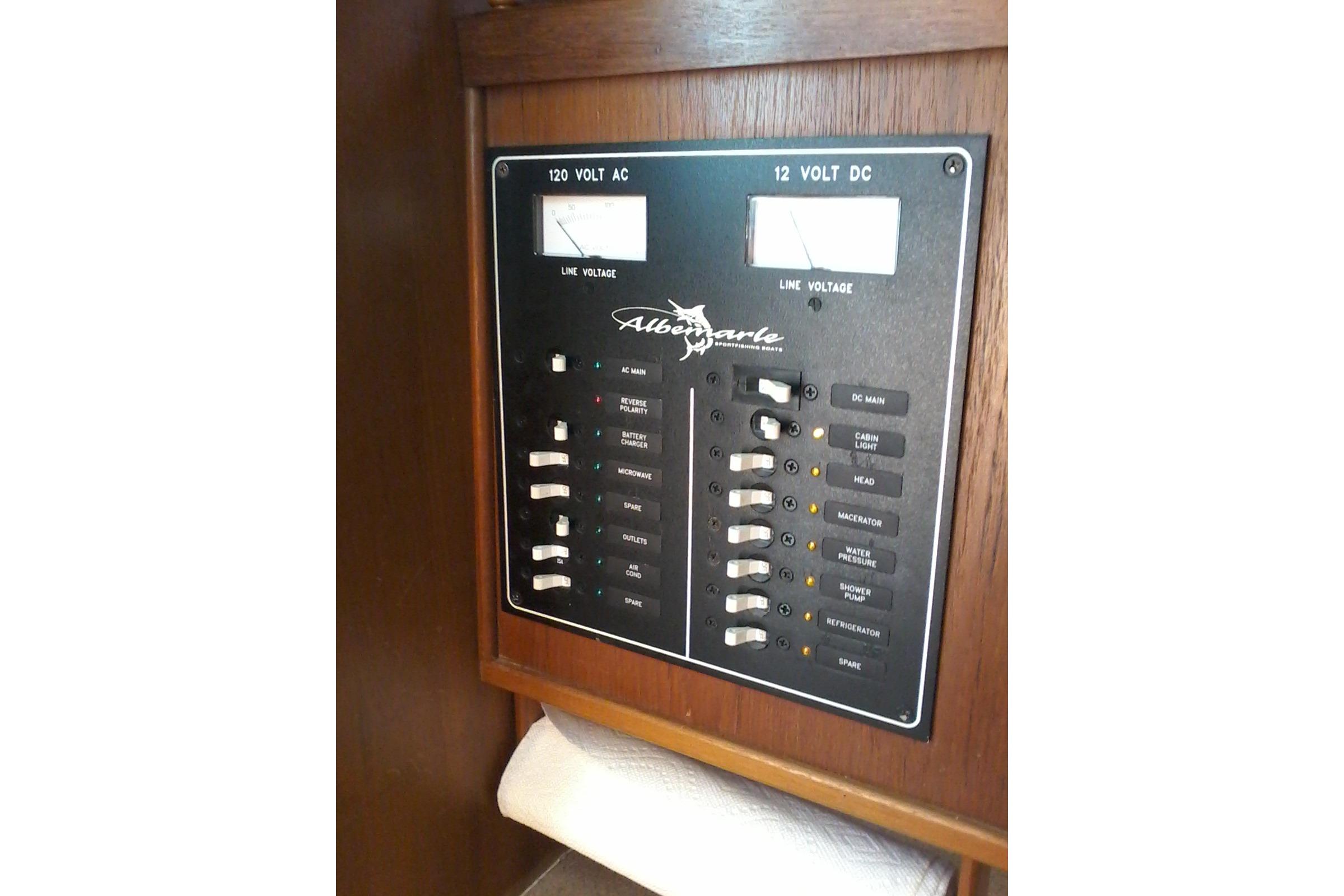 Control panel of a 2002 Albemarle 265 Express Fisherman boat, featuring AC and DC switches.