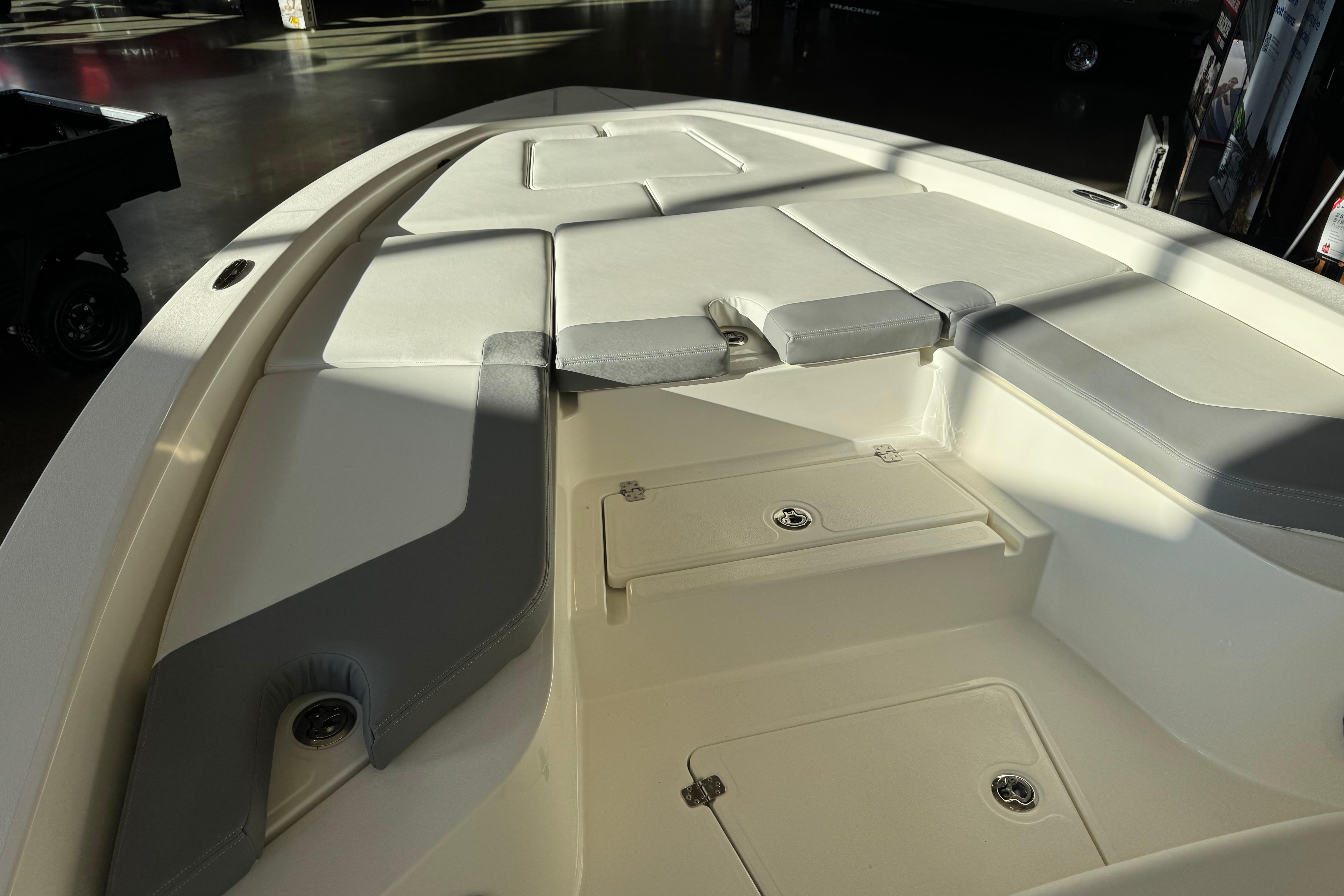 2026 Mako 24 APEX boat interior with cushioned seating and storage compartments.