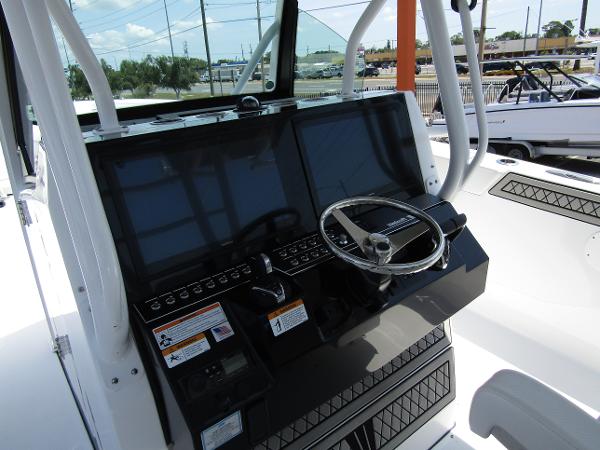 2024 Wellcraft 352 Fisherman boat dashboard with dual screens and steering wheel.
