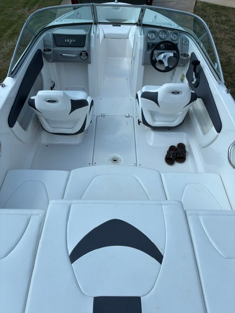 Interior view of a 2012 Chaparral 19 H2O Sport boat with white seats and dashboard.