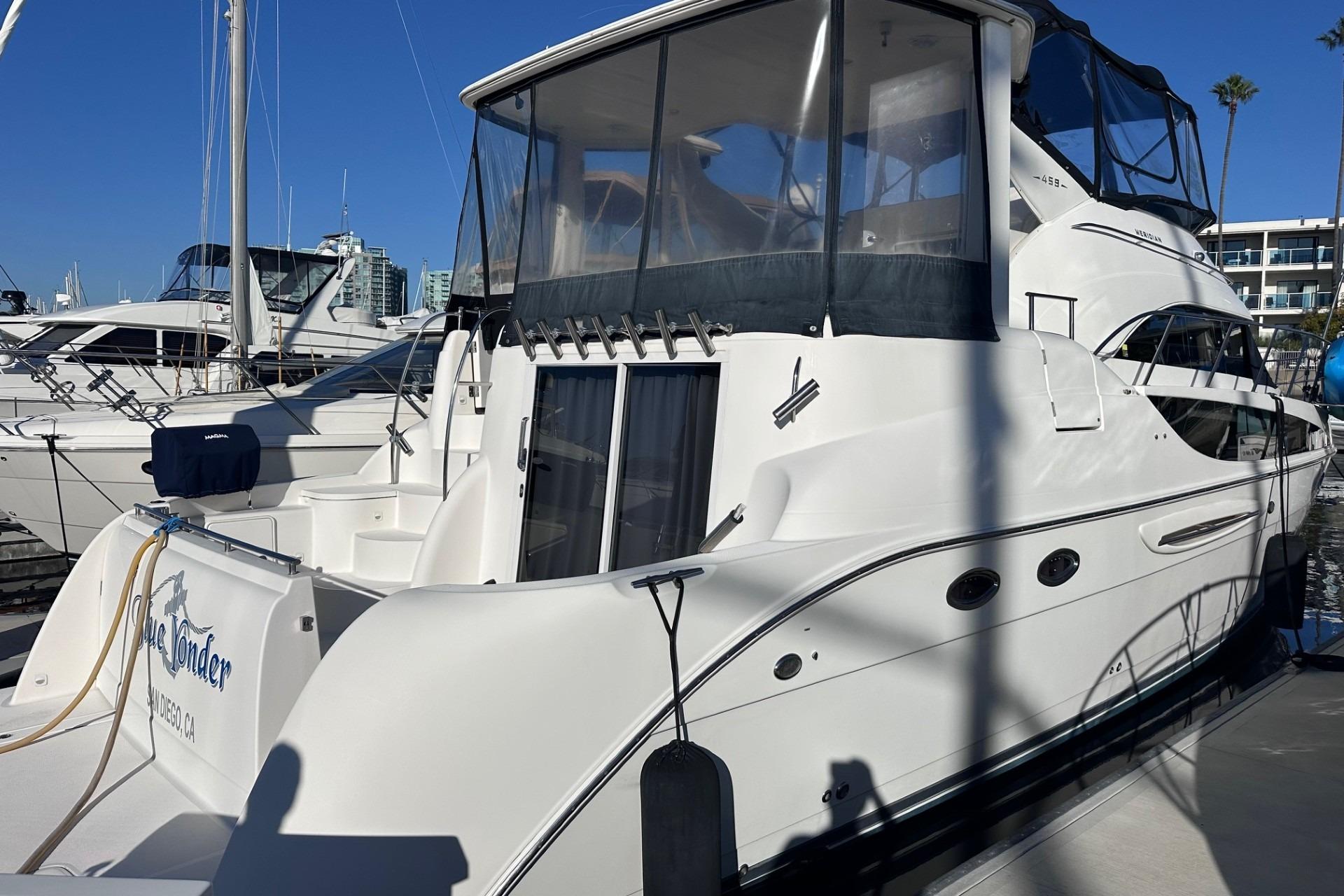 2004 Meridian 459 Motoryacht docked at marina under clear blue sky.