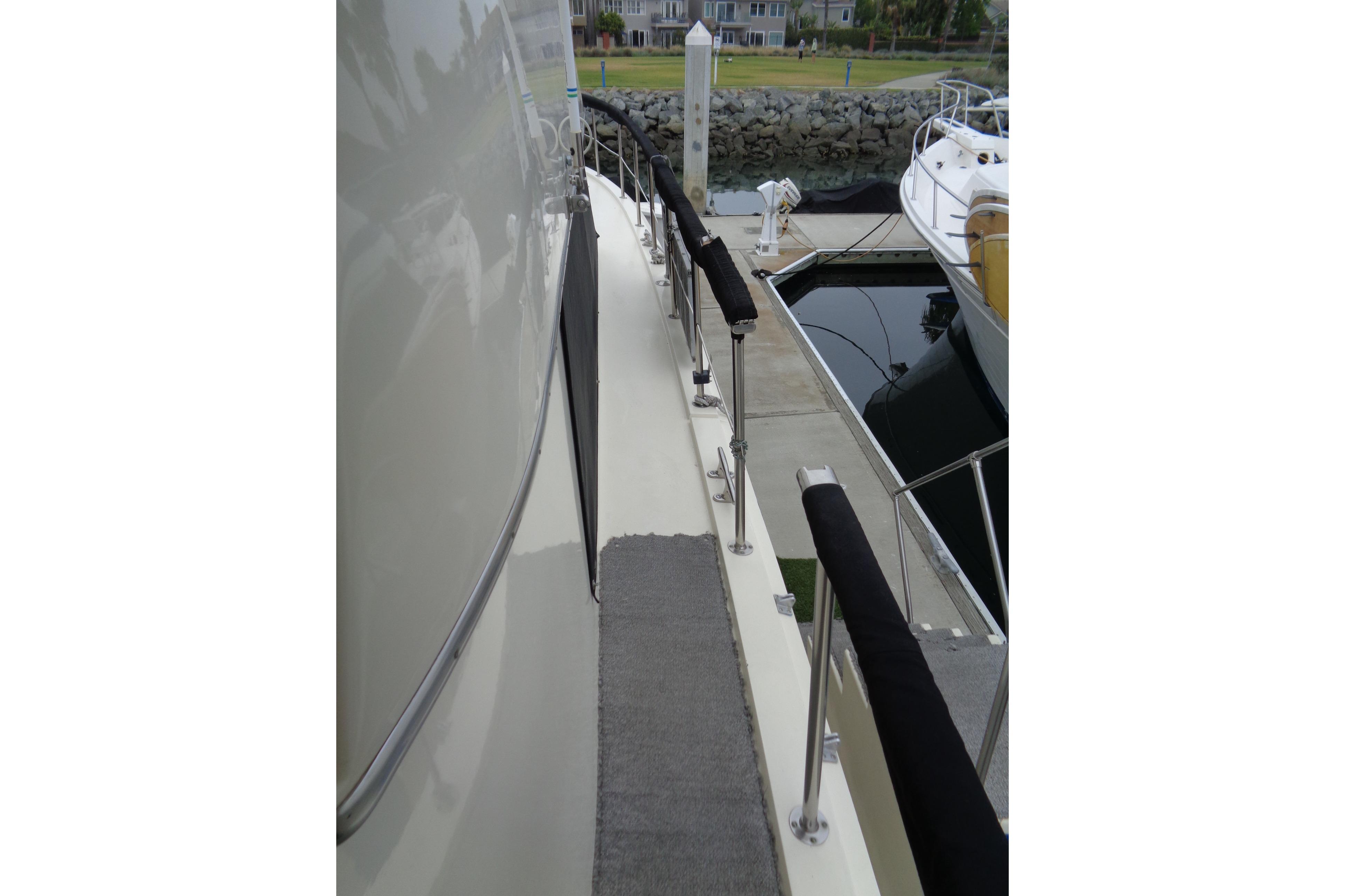 1981 Hatteras 48 Cockpit Motor Yacht docked, showing side deck and railing.
