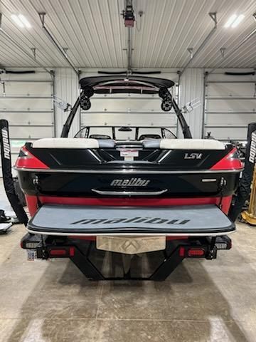 A 2009 Malibu Wakesetter 23 LSV is parked in a garage.