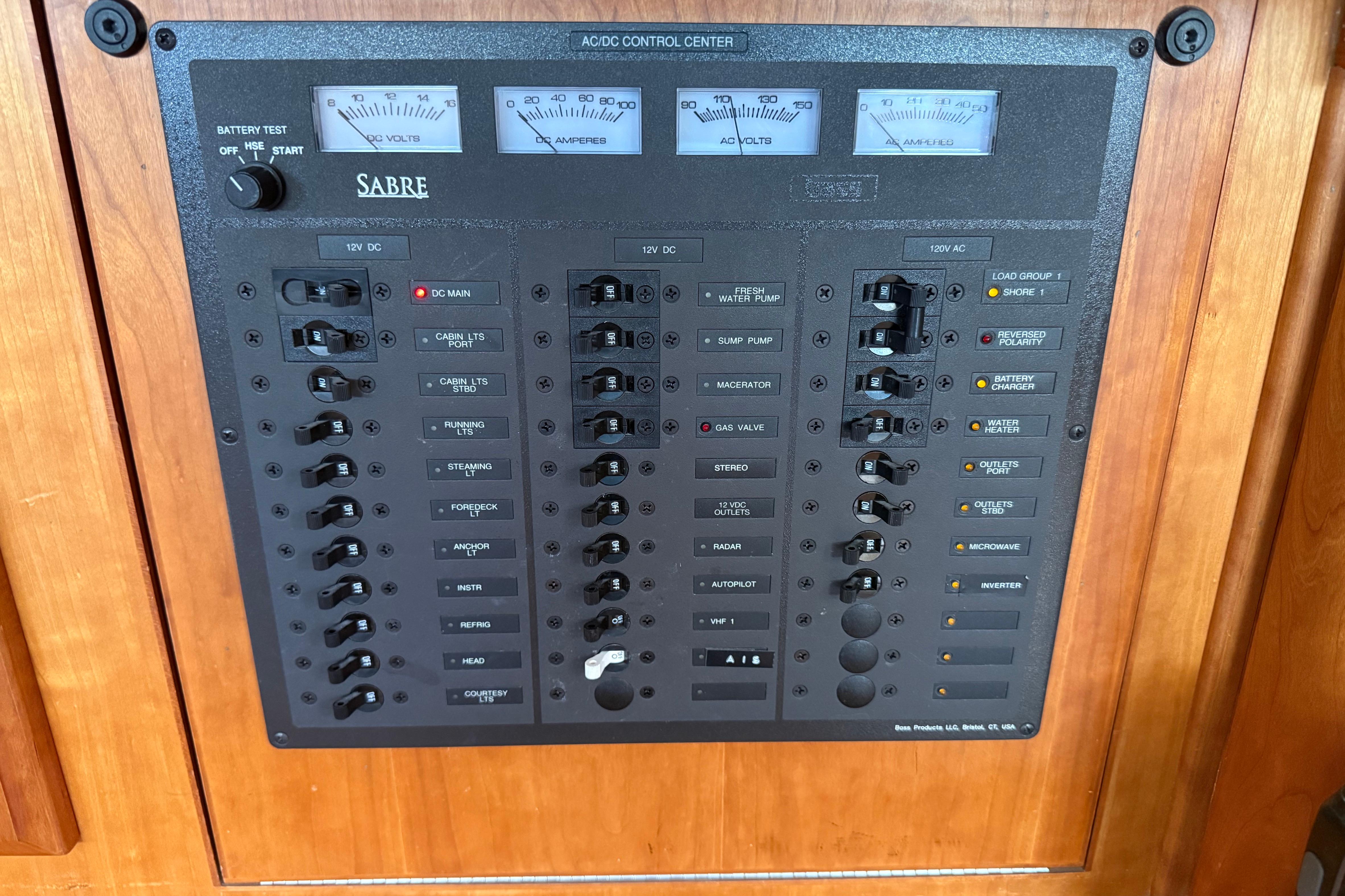Electrical control panel on a 2004 Sabre 386 boat, featuring various switches and gauges.