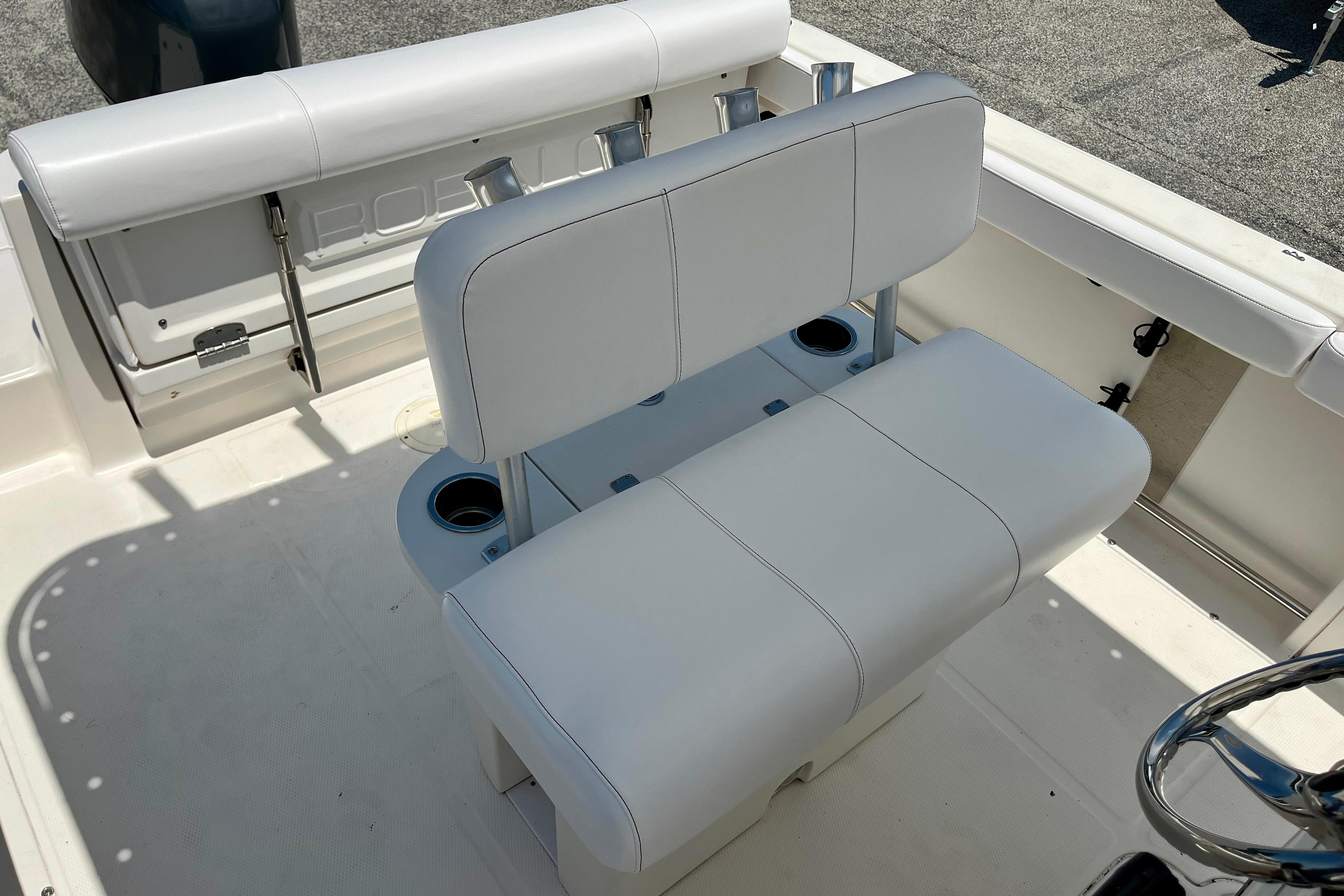 2016 Robalo R222 Center Console boat interior with white seating and cup holders.