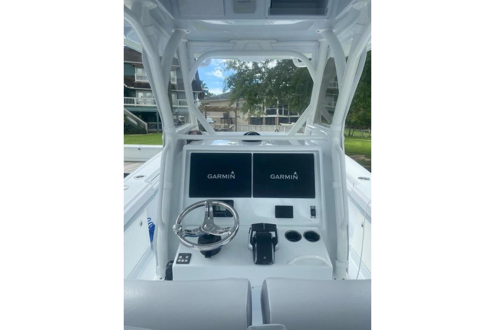 2022 Yellowfin 32 boat dashboard with Garmin displays and steering wheel.