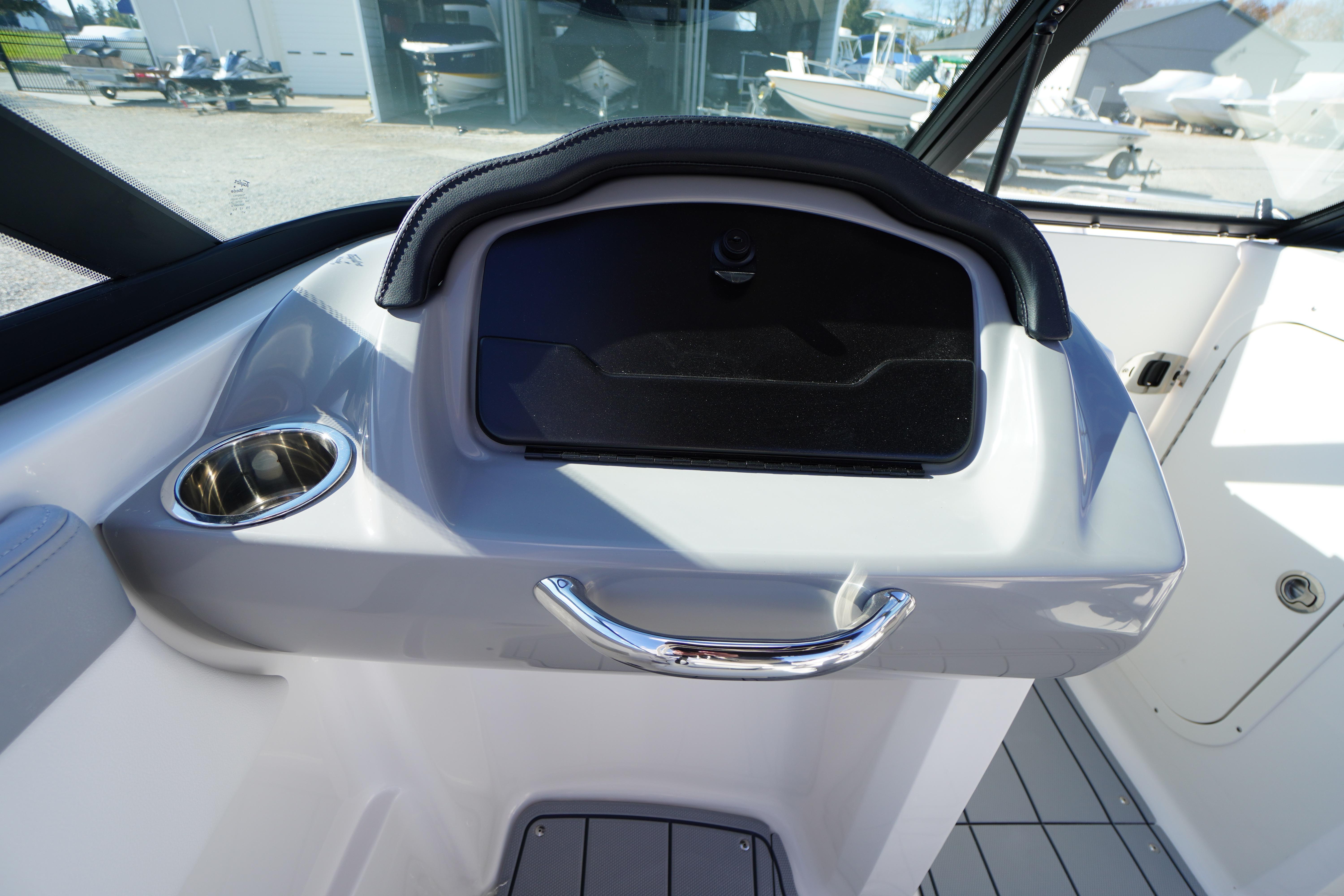 2026 Chaparral 23 SSi OB boat dashboard with cup holder and storage compartment.