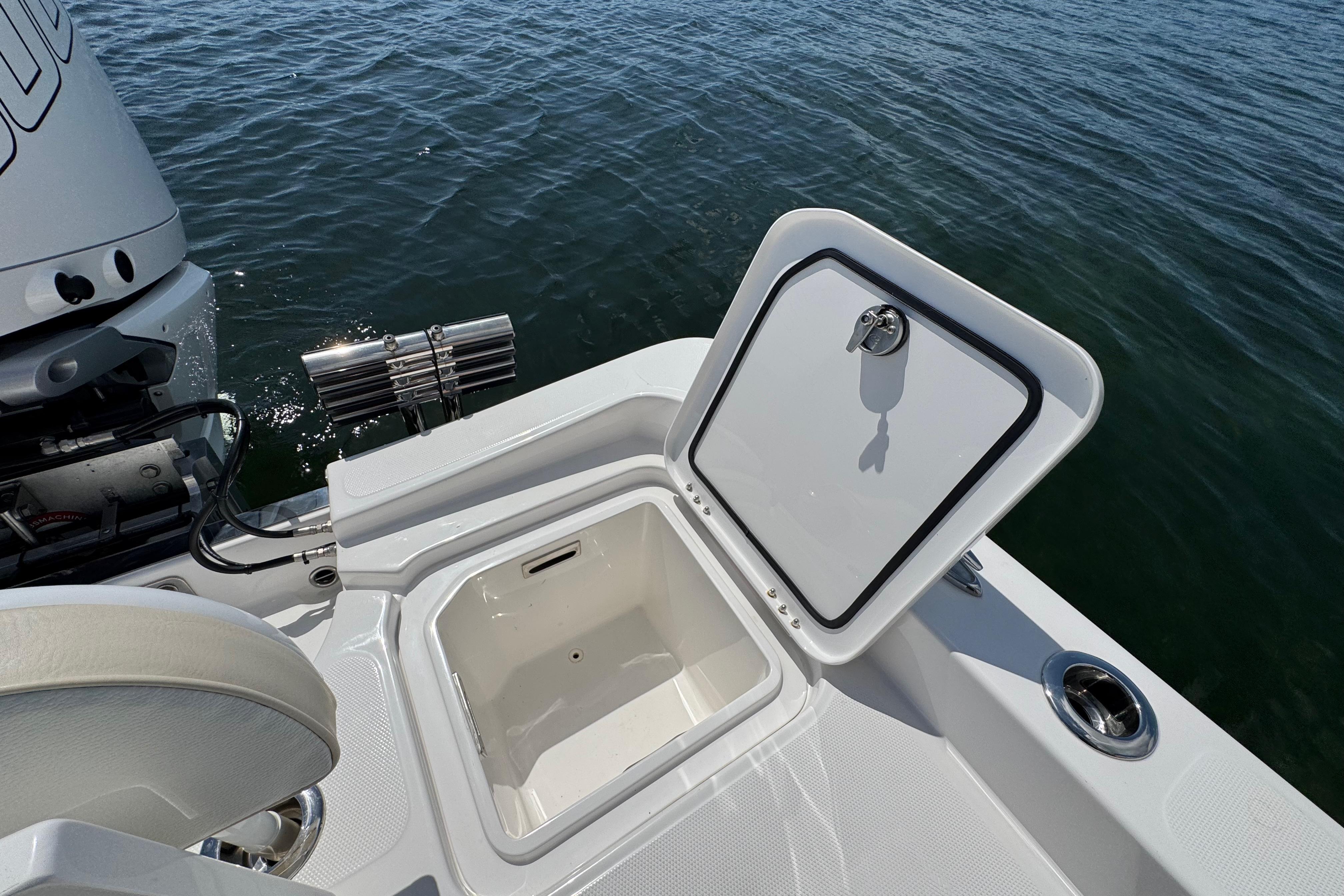 Open storage compartment on 2025 Blackwater 23 Bay boat, near water surface.
