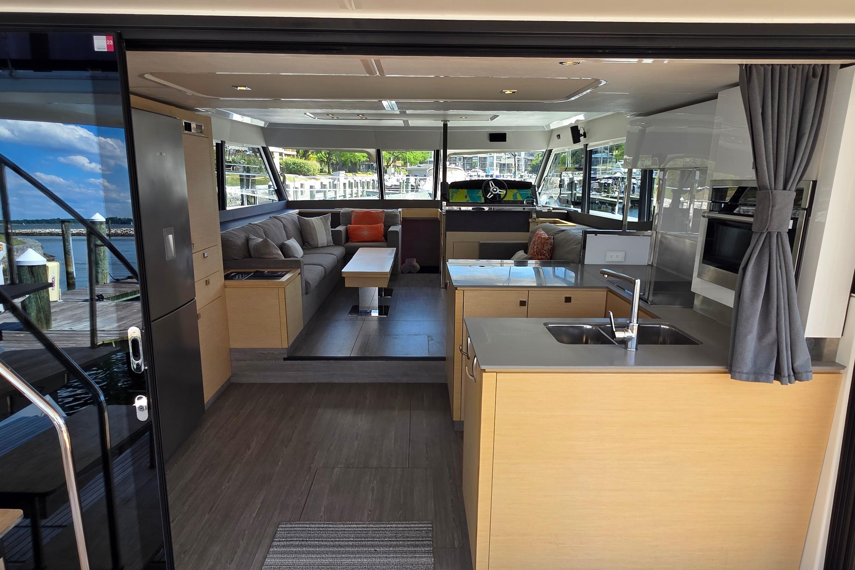 Luxurious interior of 2018 Fountaine Pajot Motor Yacht 44 with modern kitchen and seating area.