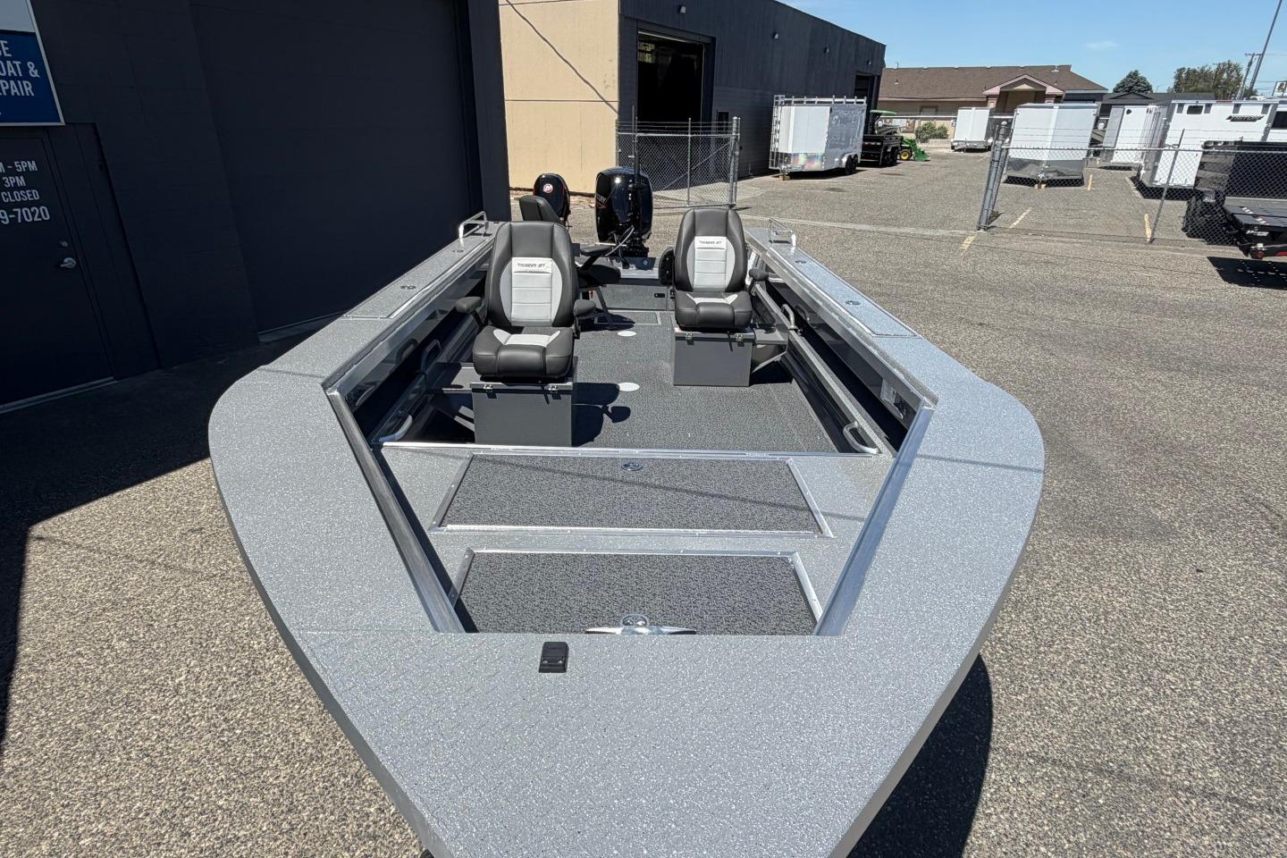 2026 Thunder Jet 209 Rush OT boat with dual seats, parked outdoors.