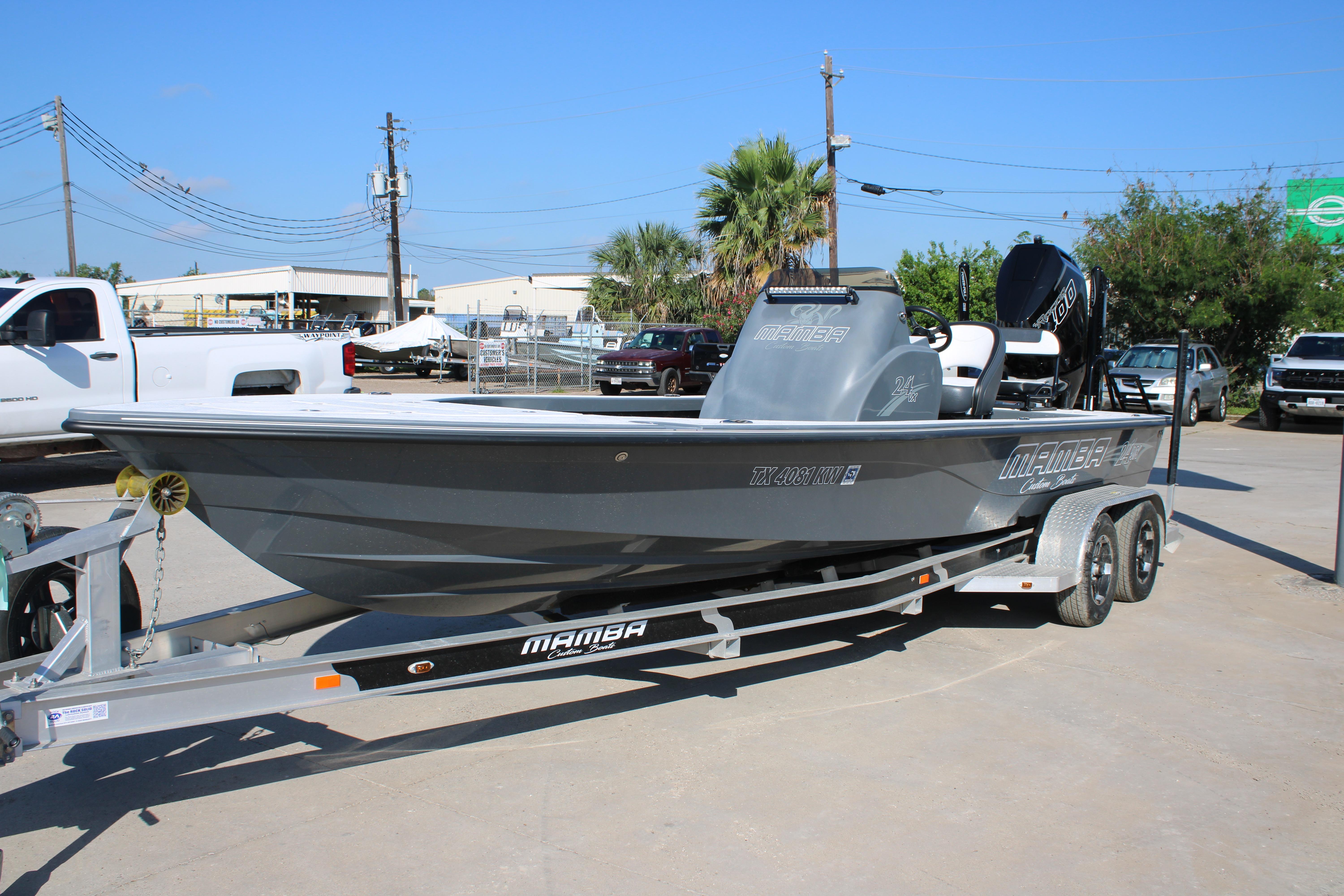 2023 Mamba 24VX boat on trailer, parked outdoors, showcasing sleek design and modern features.
