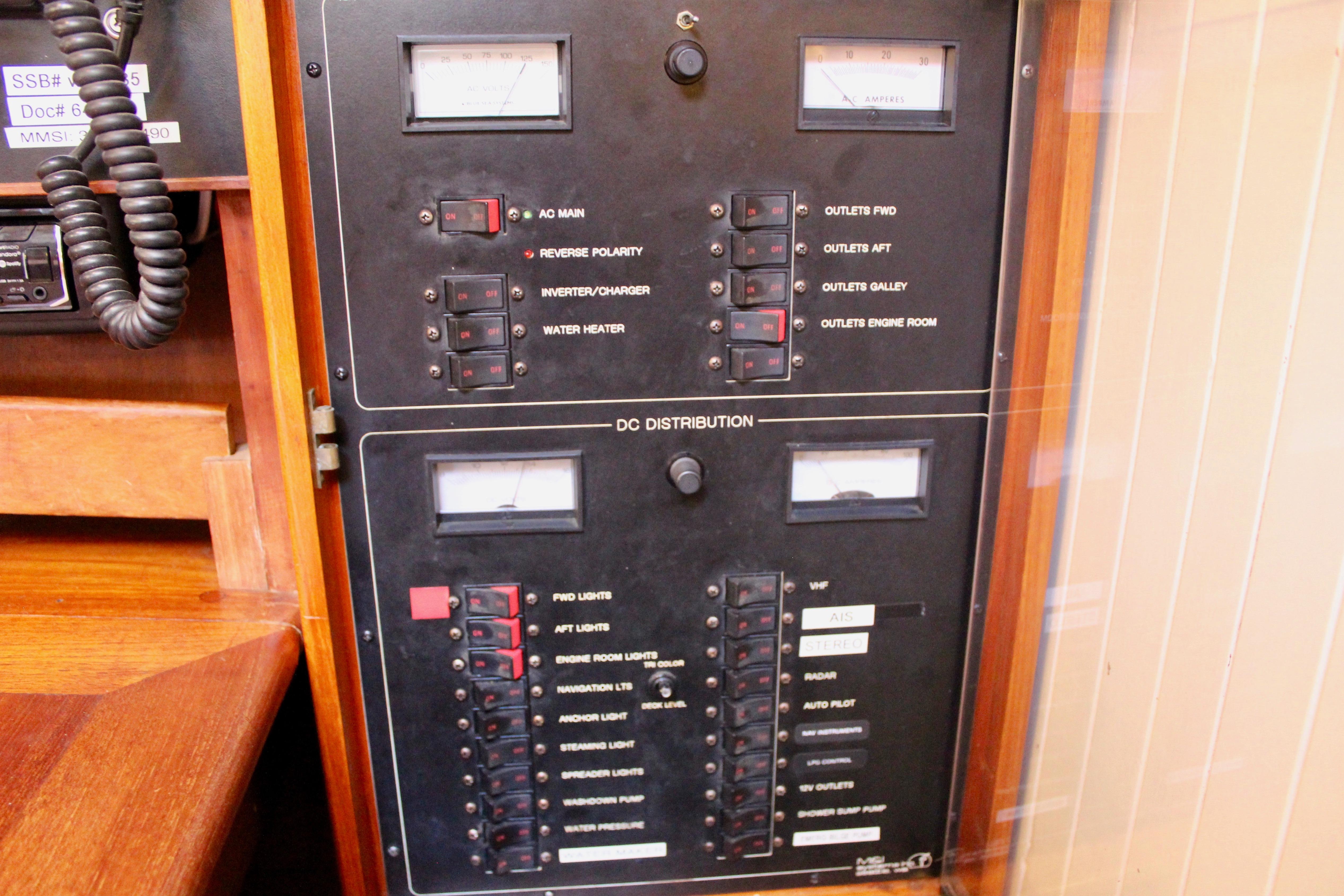Electrical panel on a 1981 Kelly Peterson 46 sailboat, featuring various switches and gauges.