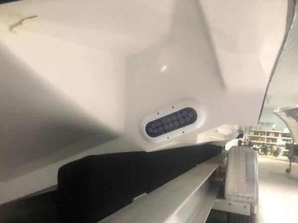 2019 Midnight Express 39 Cuddy boat hull with LED lights on trailer.