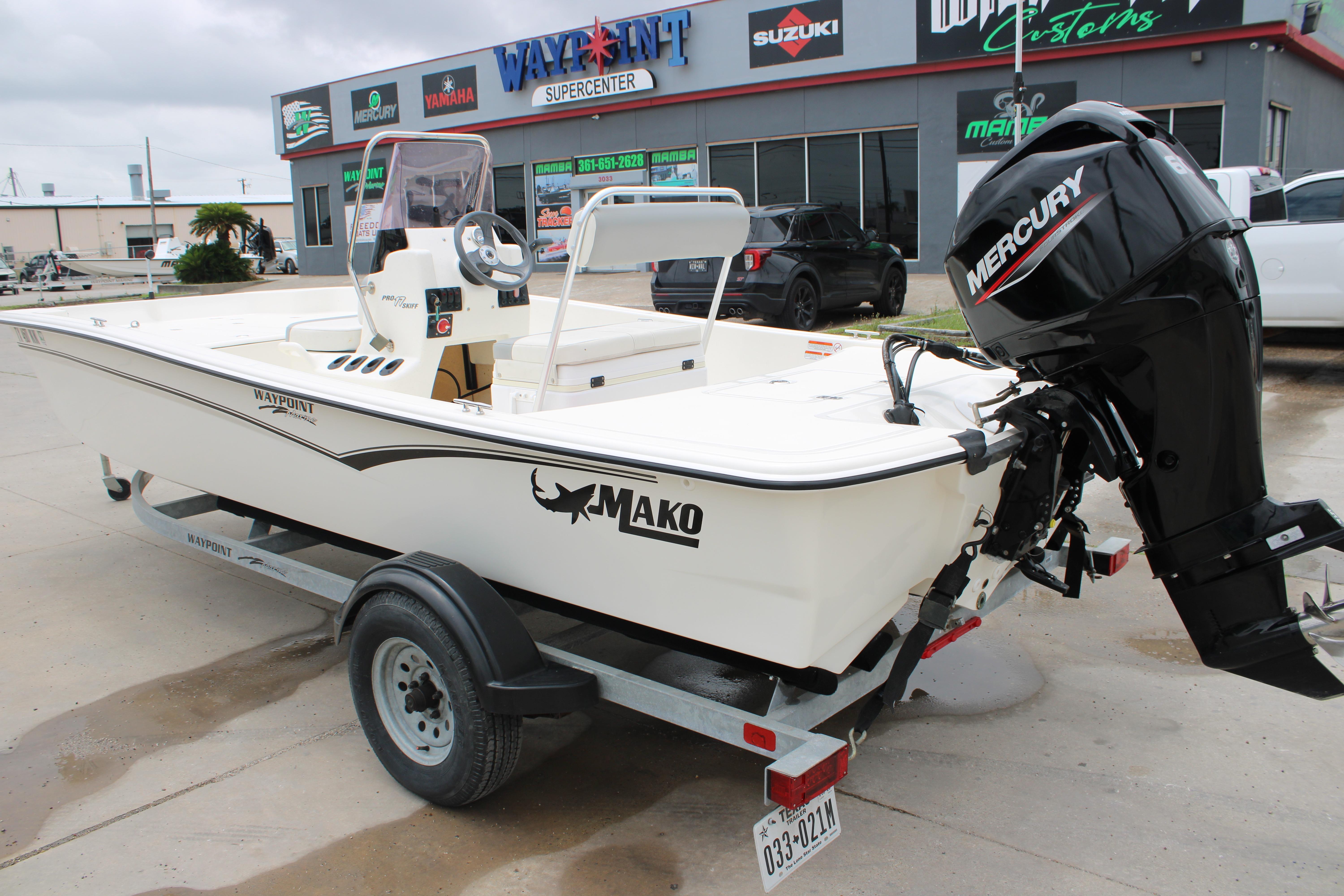 2021 Mako Pro Skiff 17 CC boat with Mercury engine on trailer at dealership.