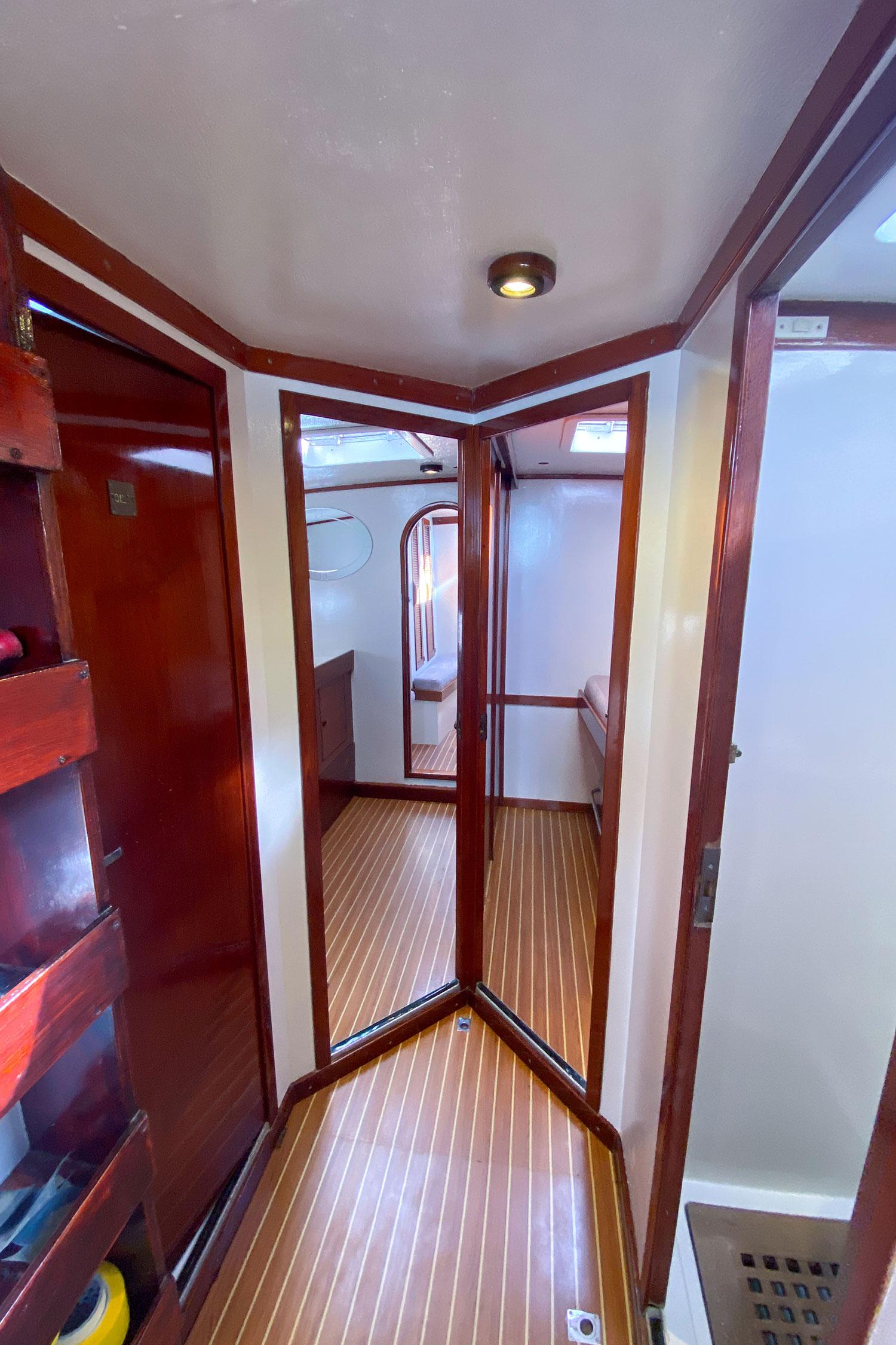 Interior of 1979 Southern Ocean Ocean 60 yacht with wood paneling and cozy cabin layout.