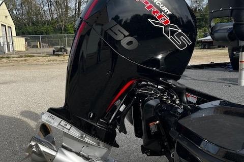 Outboard motor on a 2026 Nitro Z18 Pro boat, parked outdoors.
