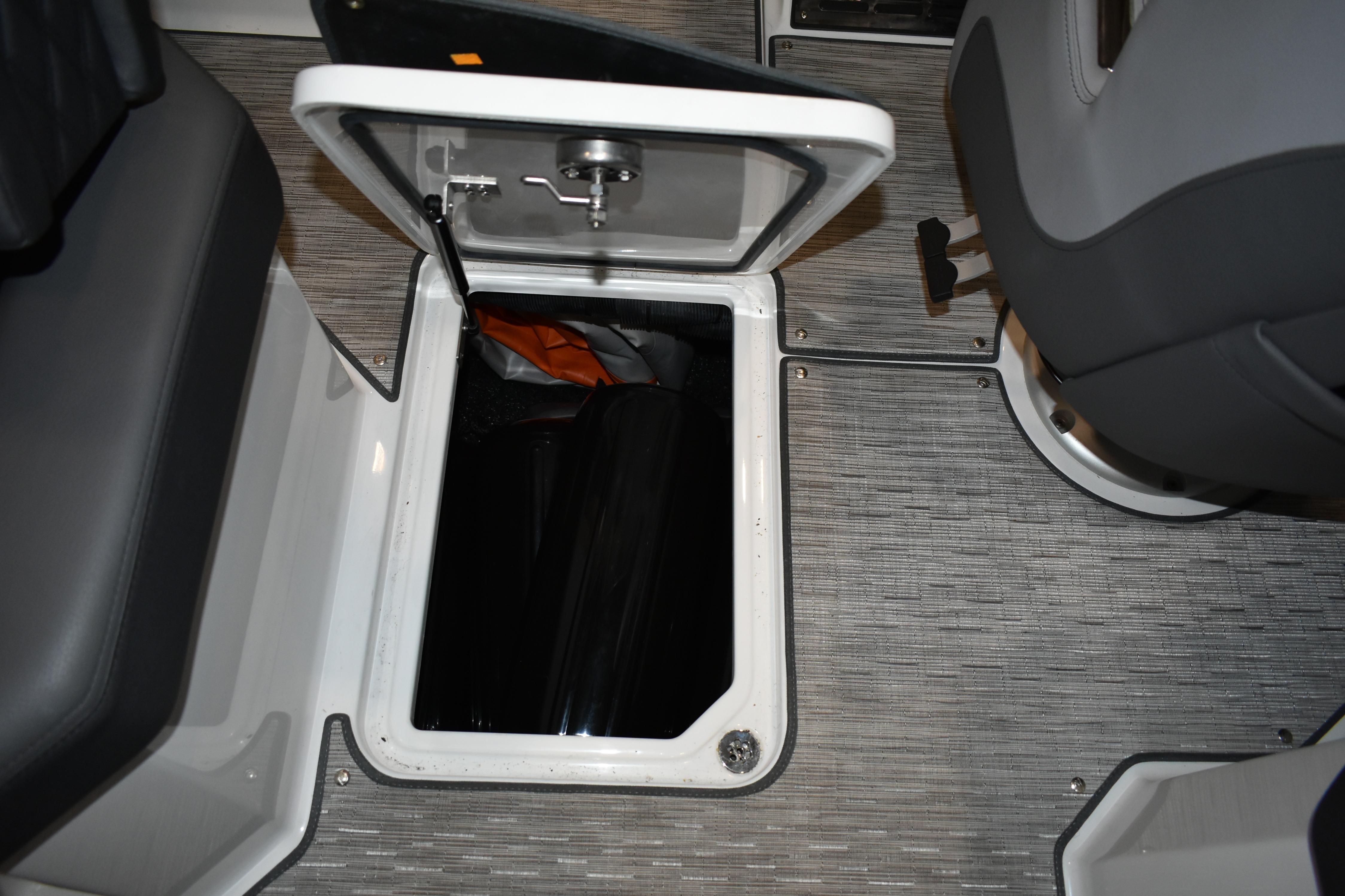 Open storage compartment in 2023 Cobalt R8 boat interior.