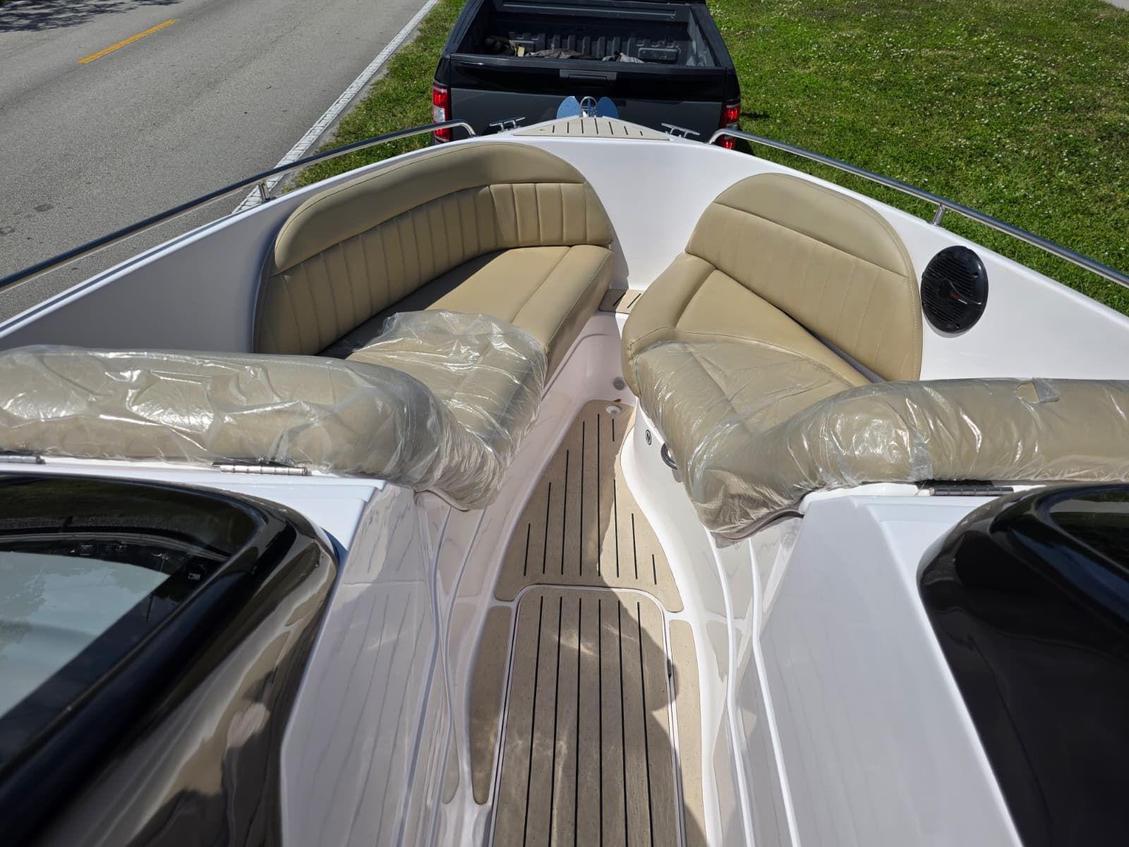 The image shows the bow of a Coral 26 boat with cushioned seating.