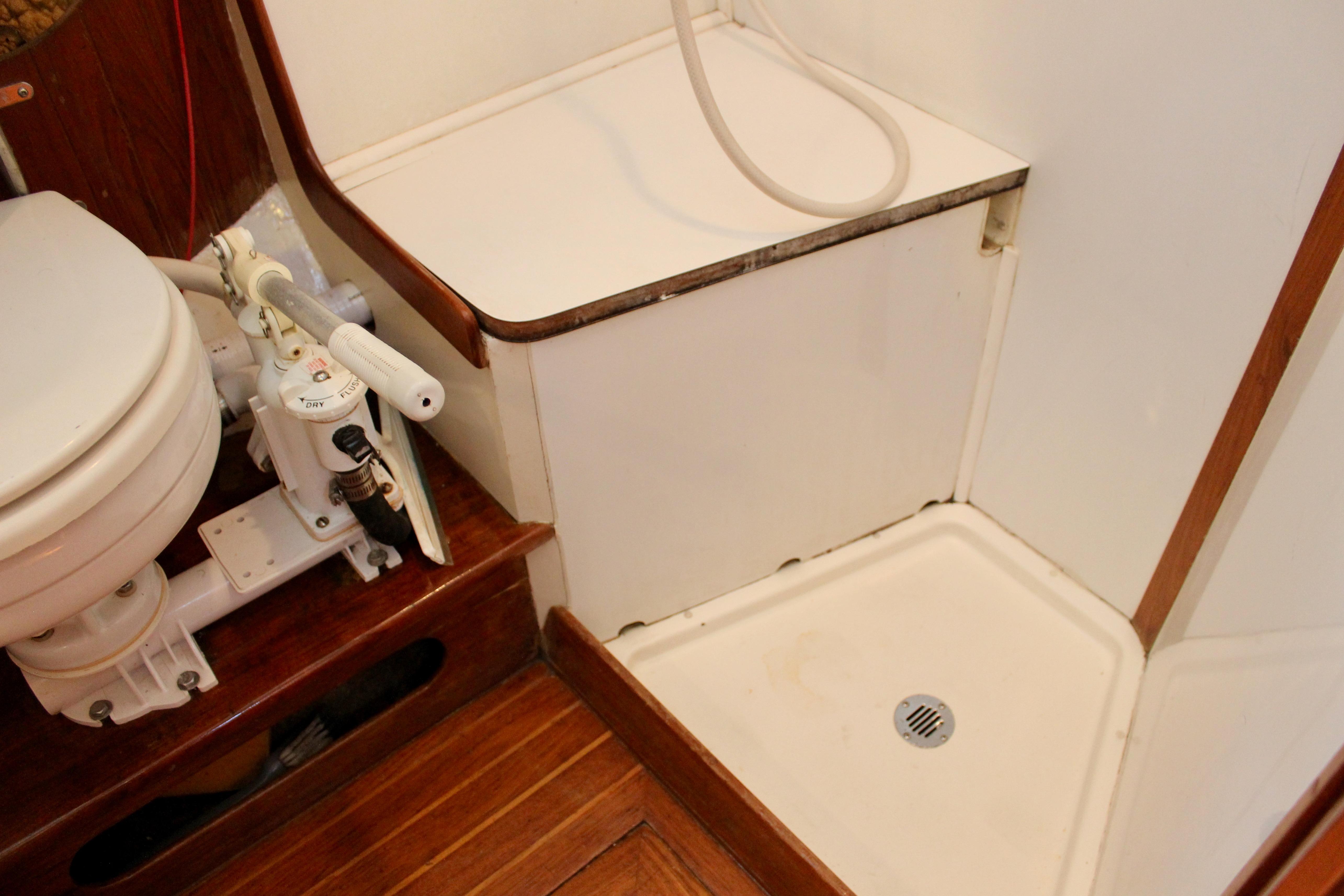 Boat bathroom with toilet and shower area on a 1981 Kelly Peterson 46 yacht.