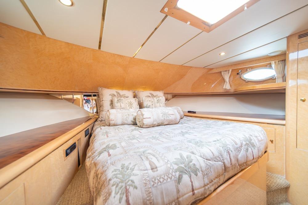 Luxurious bedroom interior of 2005 Ocean Alexander 64 Motoryacht with elegant bedding and wood finishes.