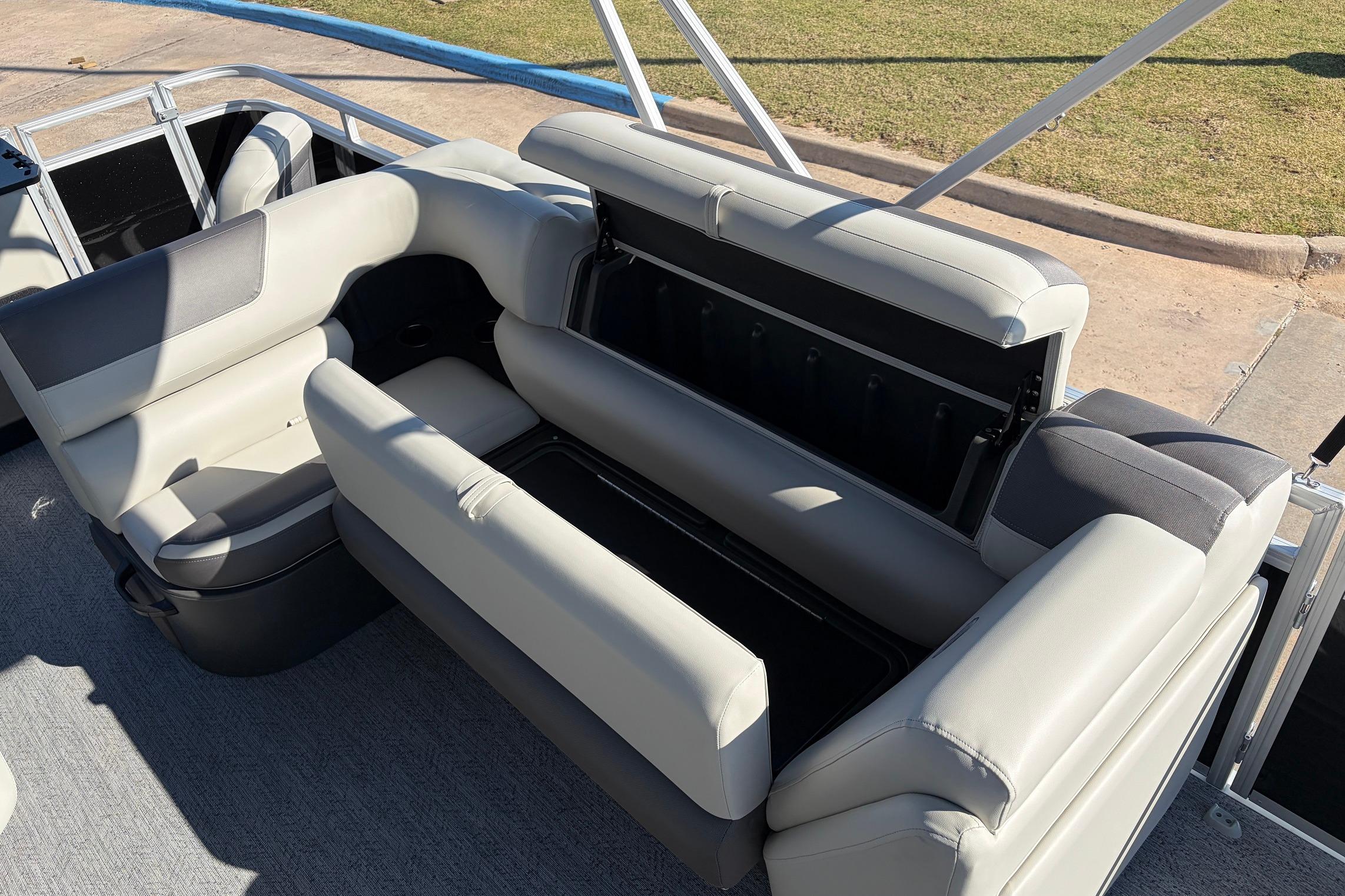 2026 Sun Tracker Fishin' Barge 22 XP3 interior seating with storage compartment open.