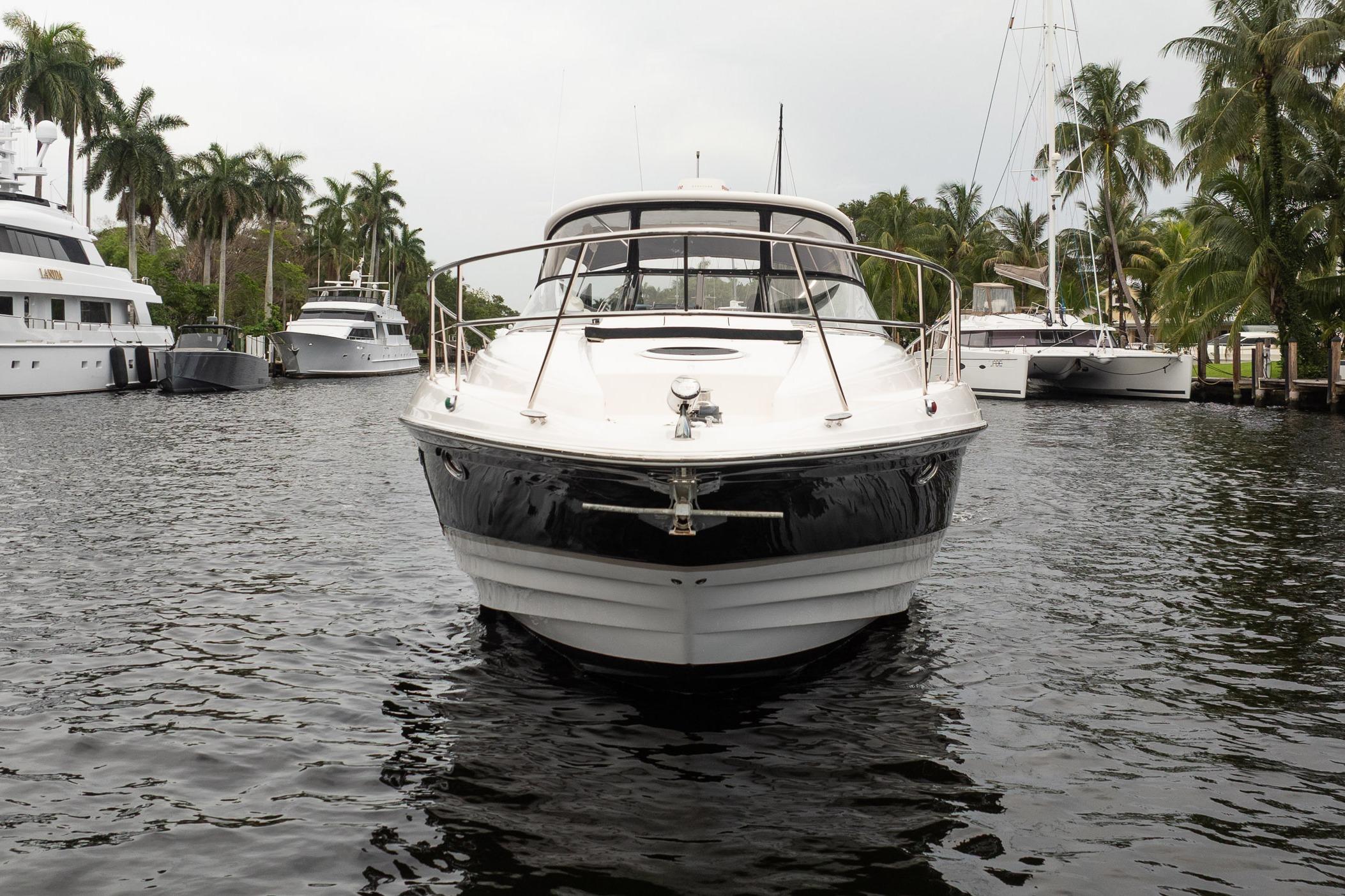 2008 Regal Commodore 4460 yacht docked in a marina with palm trees.