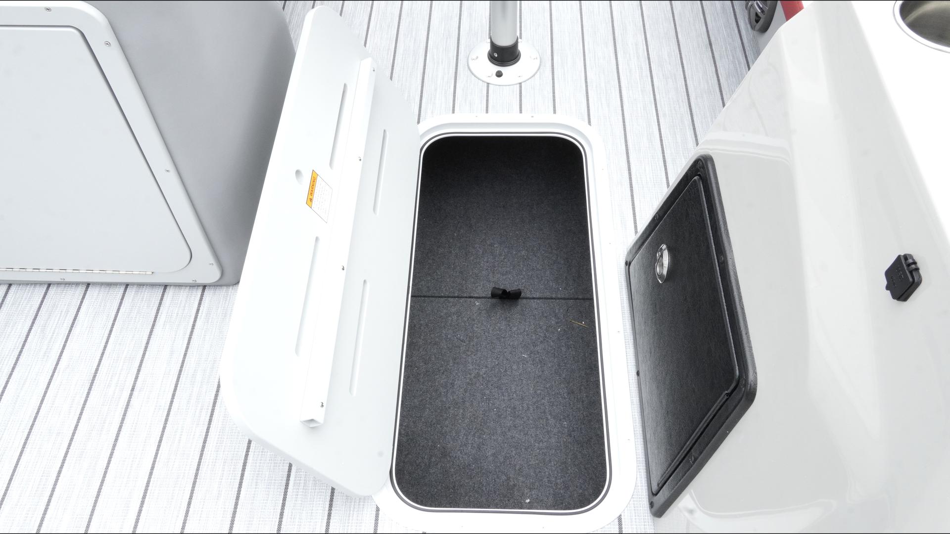 Open storage compartment on 2025 SunCatcher Select 322RC boat deck.