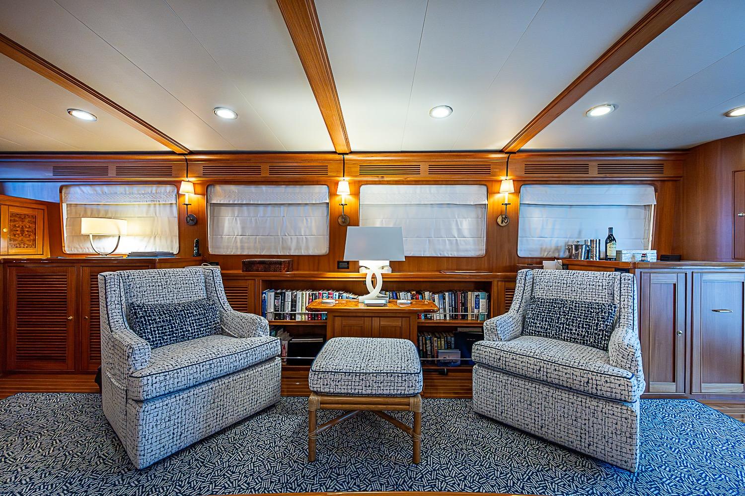 Luxurious interior of 2014 Marlow 80 Explorer yacht with elegant seating and wooden accents.