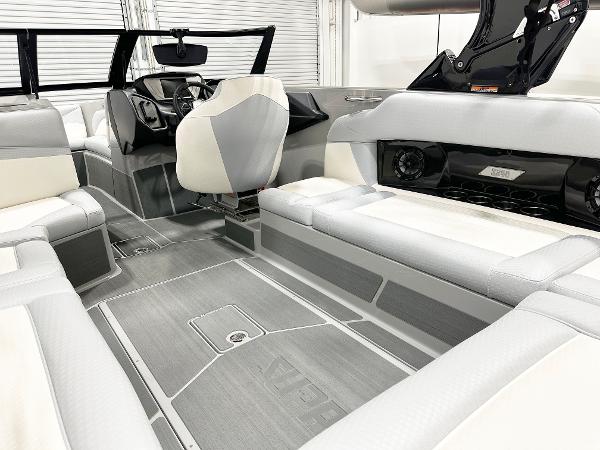 Luxurious interior of 2025 Supreme S240 boat with modern seating and sleek design.