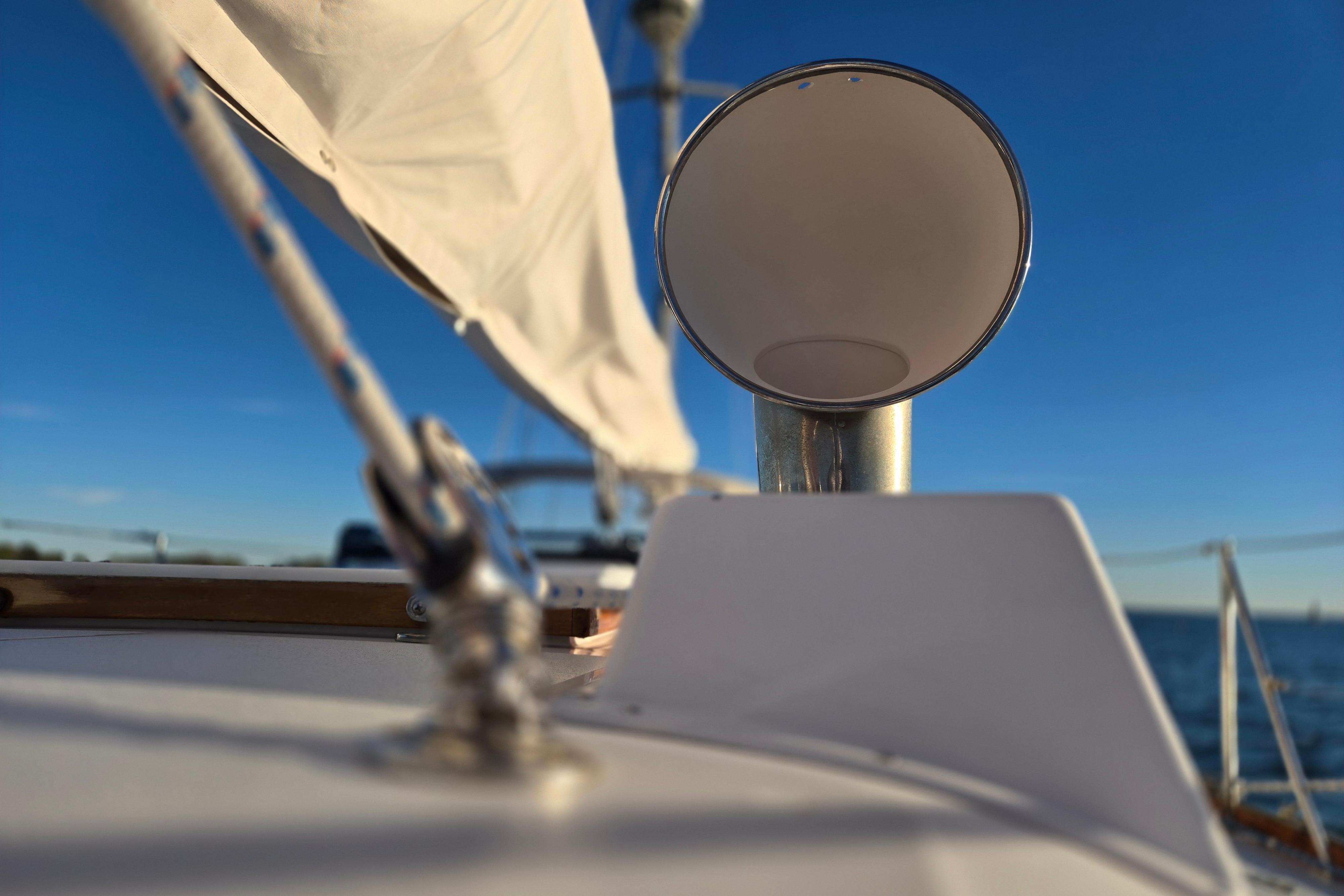 Close-up of 1970 Hinckley Bermuda 40 sailboat deck with clear blue sky.