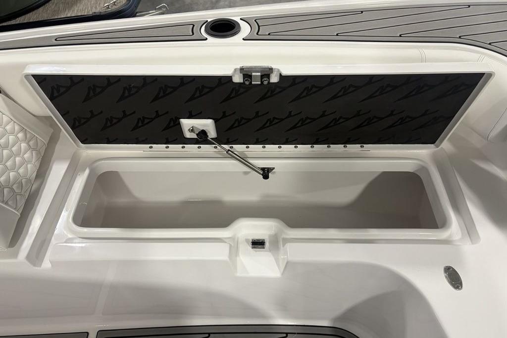 Open storage compartment on 2026 Tidewater 3100 Carolina Bay boat, featuring sleek design and functionality.