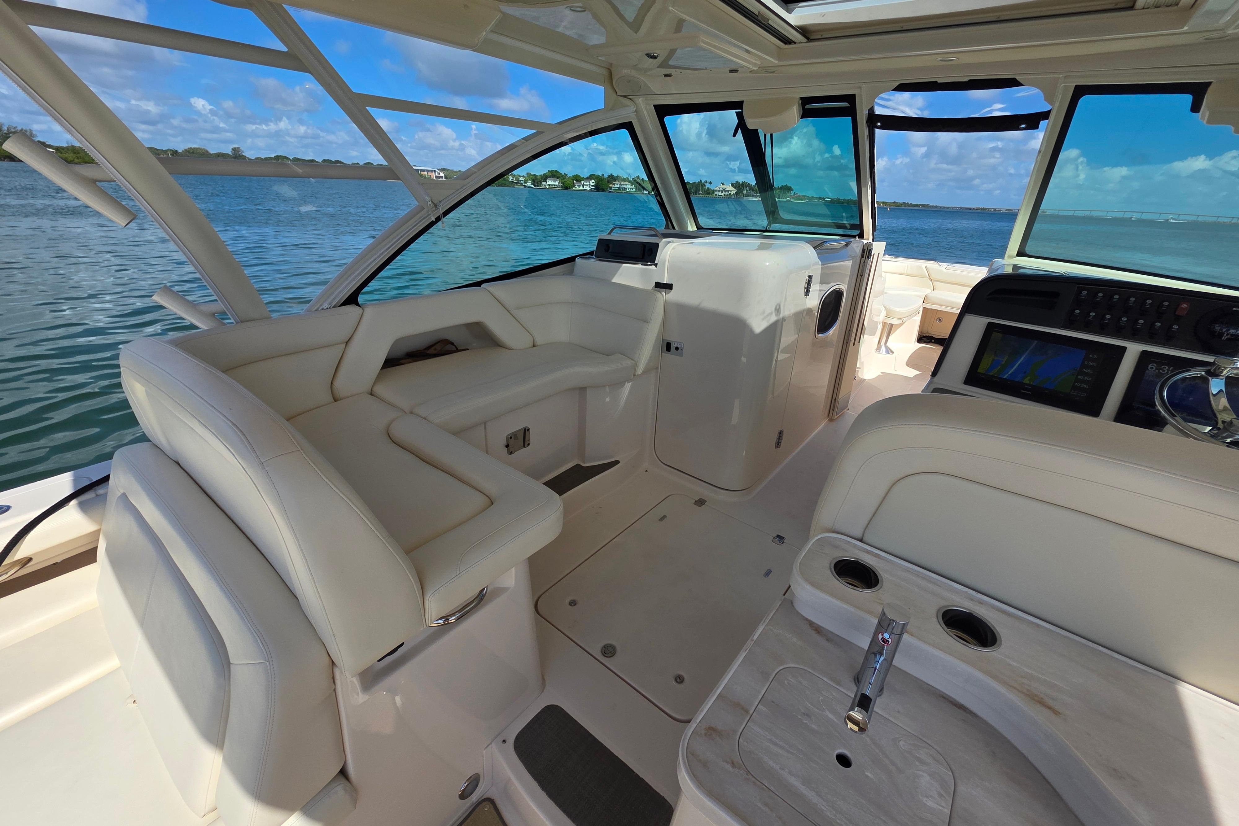 Interior of 2019 Grady-White Freedom 375 boat with luxurious seating and navigation equipment.