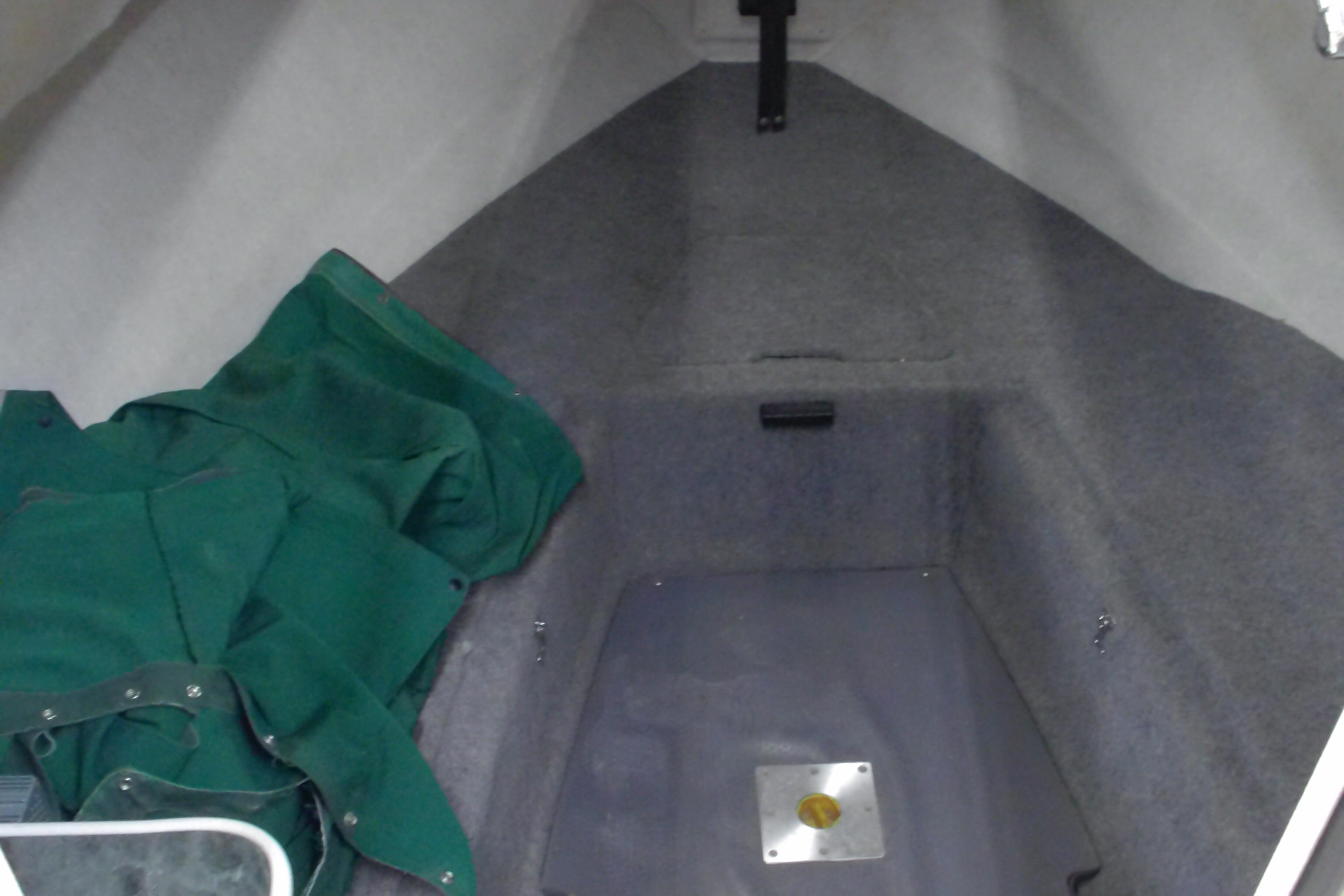 Interior cabin of a 2004 Trophy 2352 Walkaround boat with green fabric.