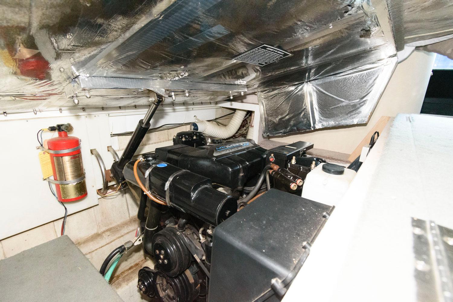 Engine room of a 1997 Bluewater Yachts 680 Custom Series with visible fire extinguisher.