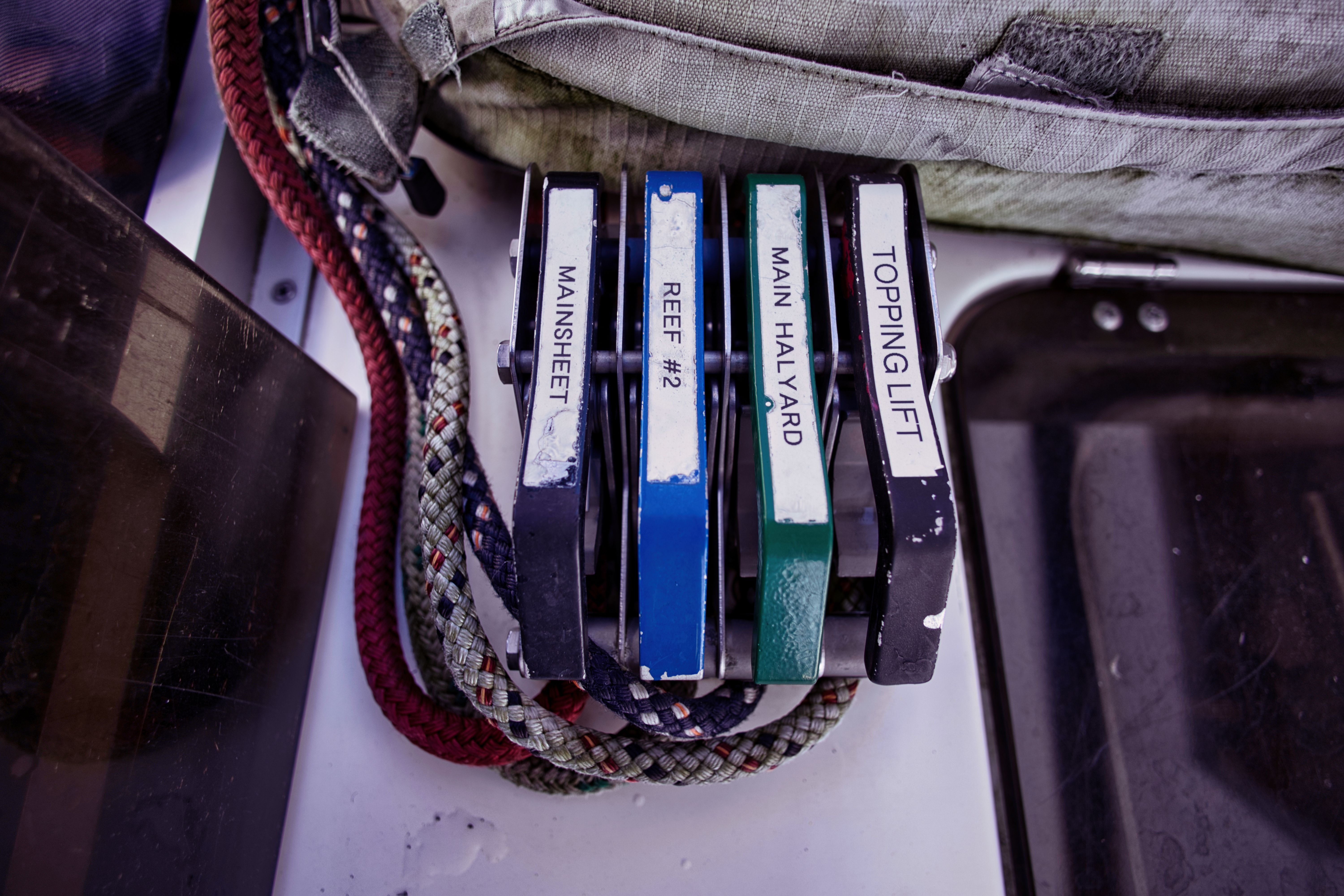 Sailboat controls with mainsheet, reef, halyard, and topping lift levers.