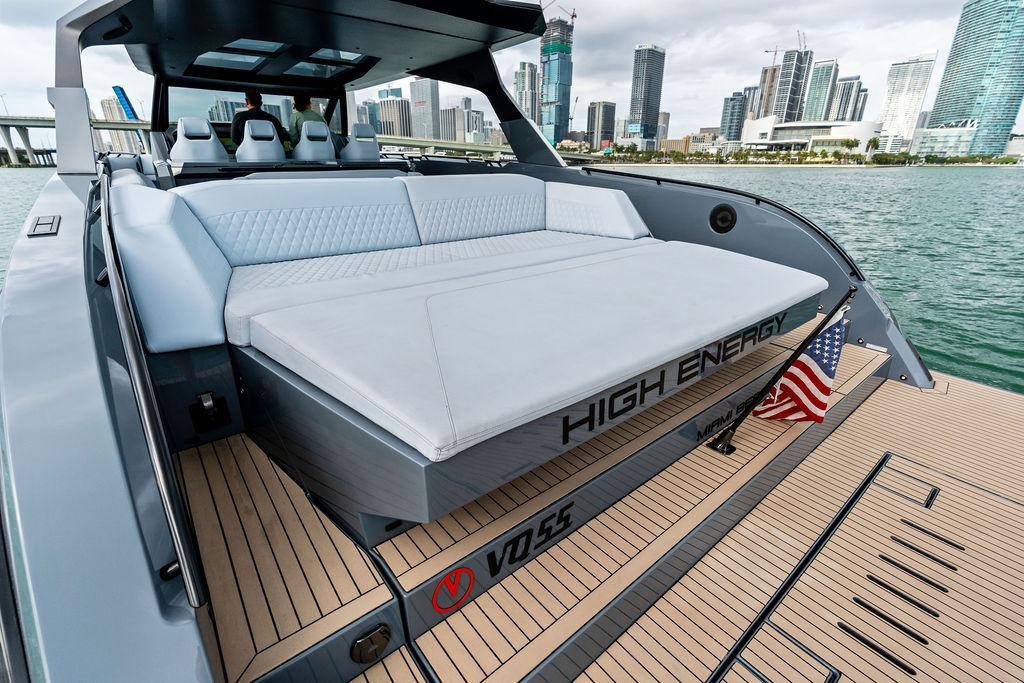2024 Vanquish Yachts VQ55 luxury yacht with spacious deck, city skyline in background.