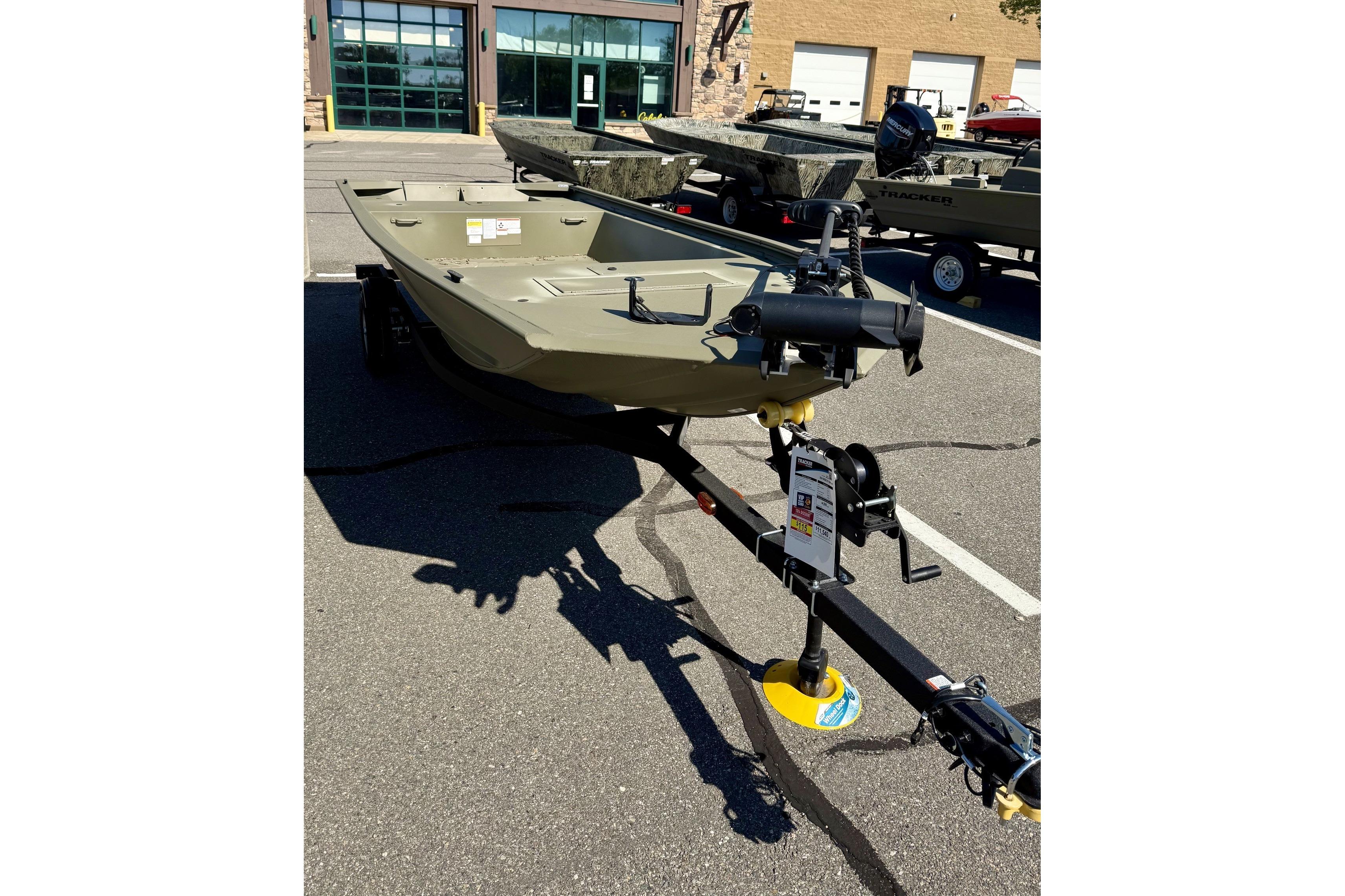 2024 Tracker Grizzly 1648 Jon boat on trailer in parking lot.