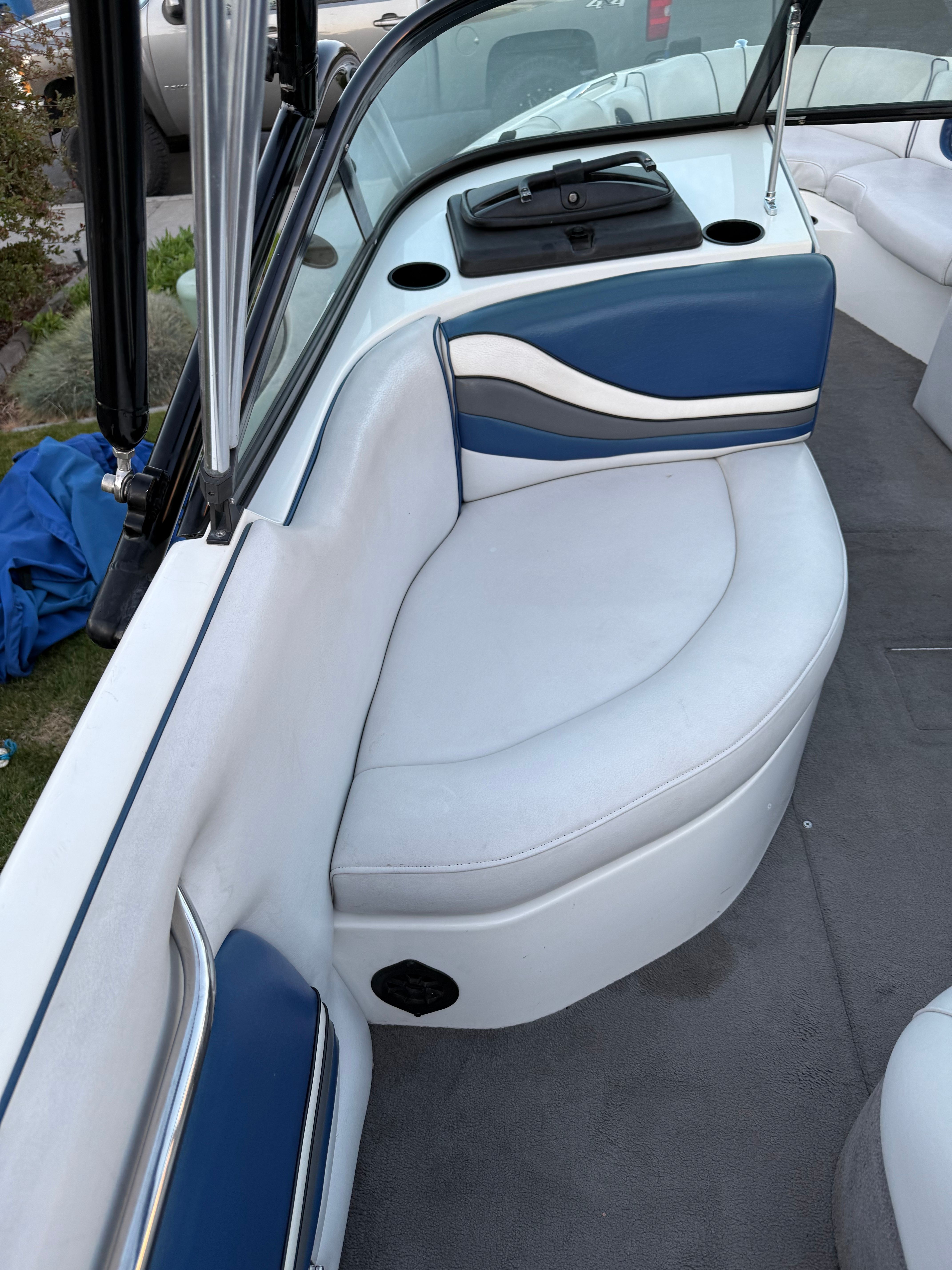 Interior of a 2004 MB Sports 220 boat with blue and white seating.