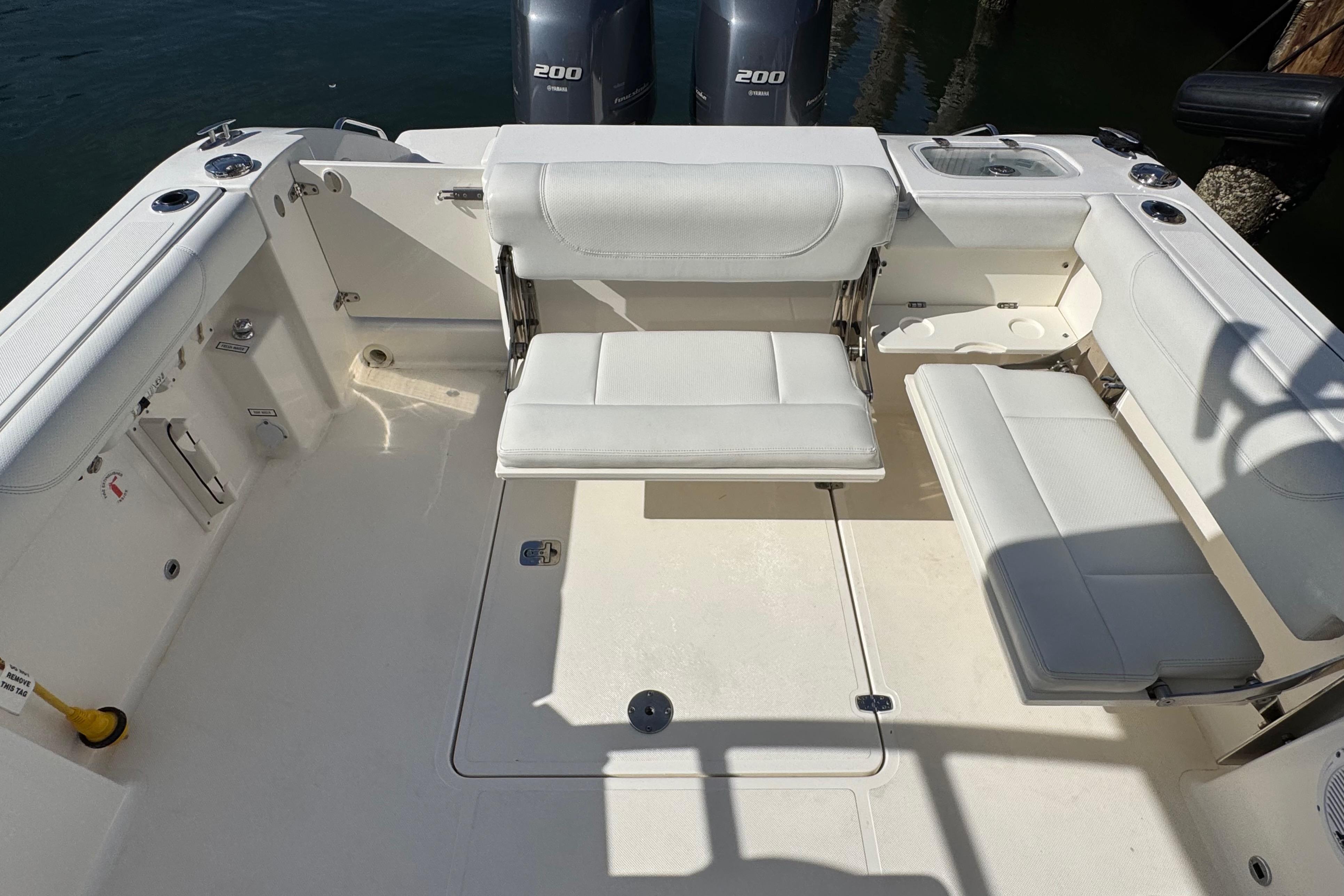 2022 Pursuit DC 266 Dual Console boat interior with white seating and twin engines.