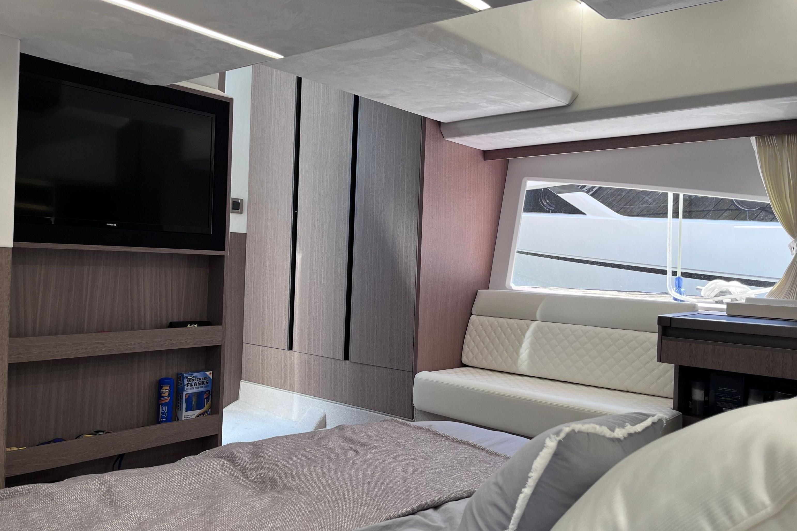 Interior of 2024 Galeon 425 HTS yacht with modern furnishings and large window view.