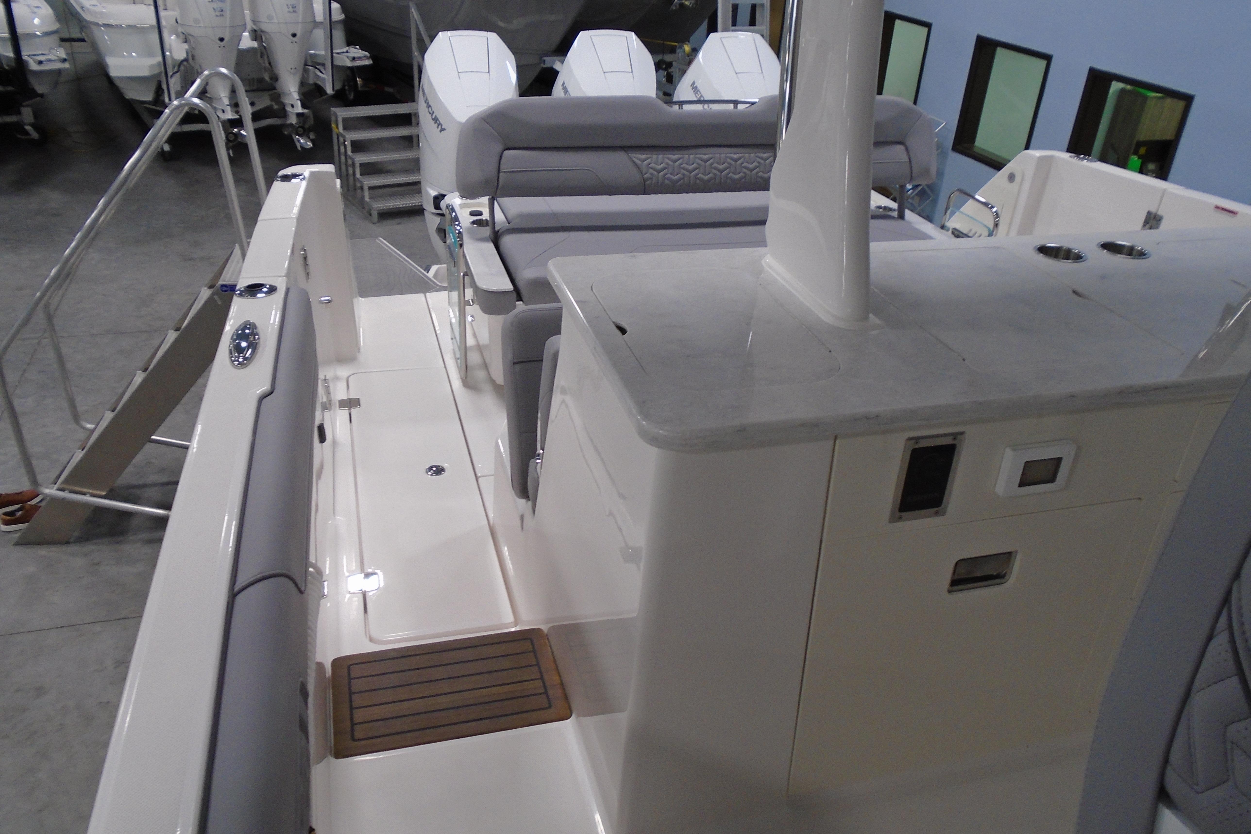 2026 Regal 38 SAV boat interior with seating and control panel in a showroom.