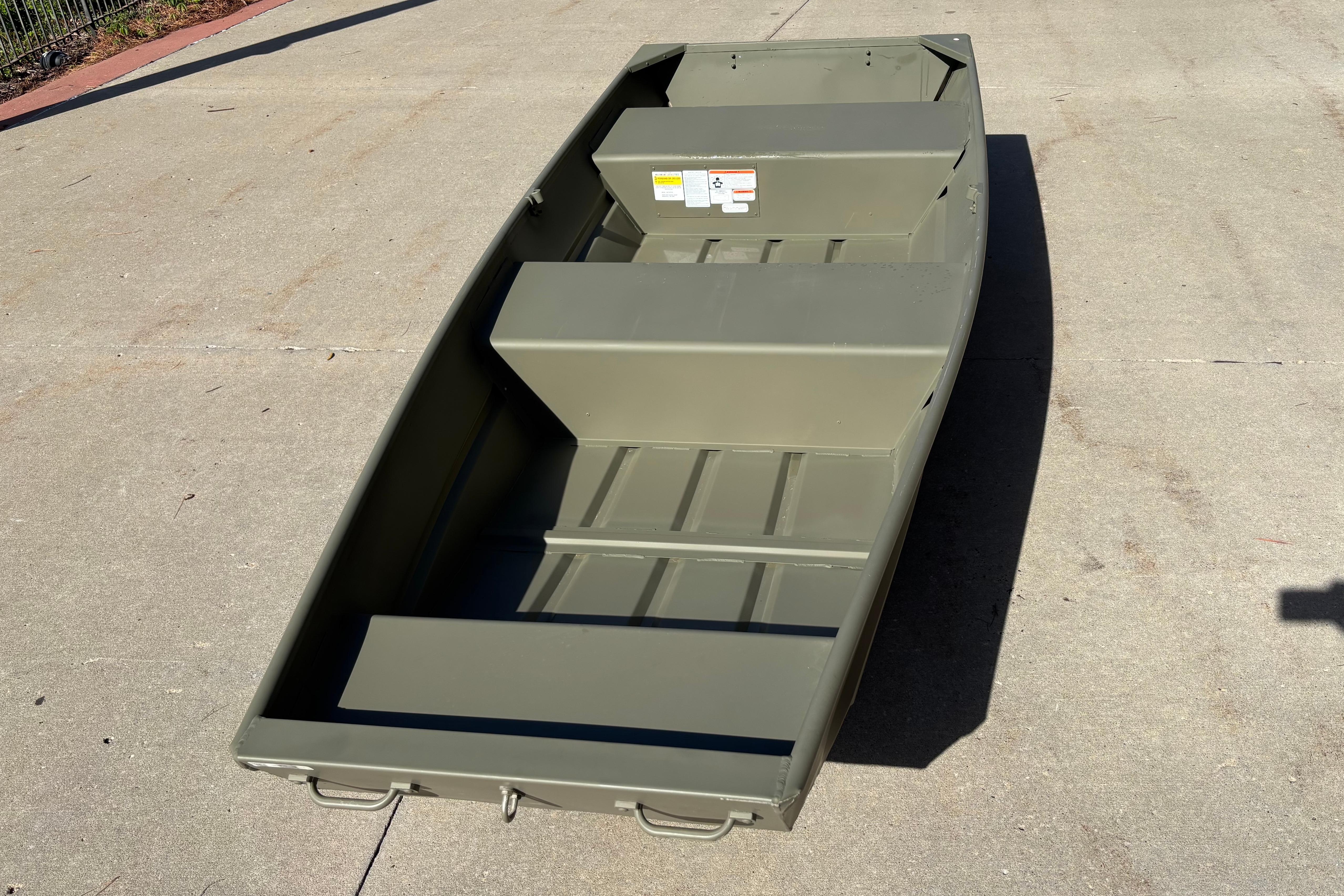 2026 Tracker Grizzly 12 Jon boat on concrete surface, showcasing its sturdy design.