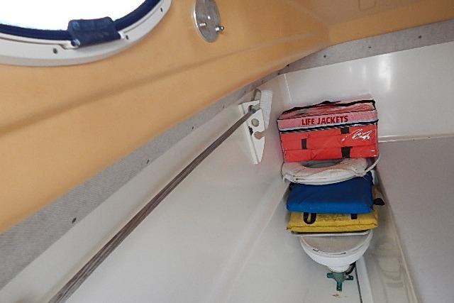 Interior of a 2003 World Cat 270 EC boat with life jackets neatly stored.