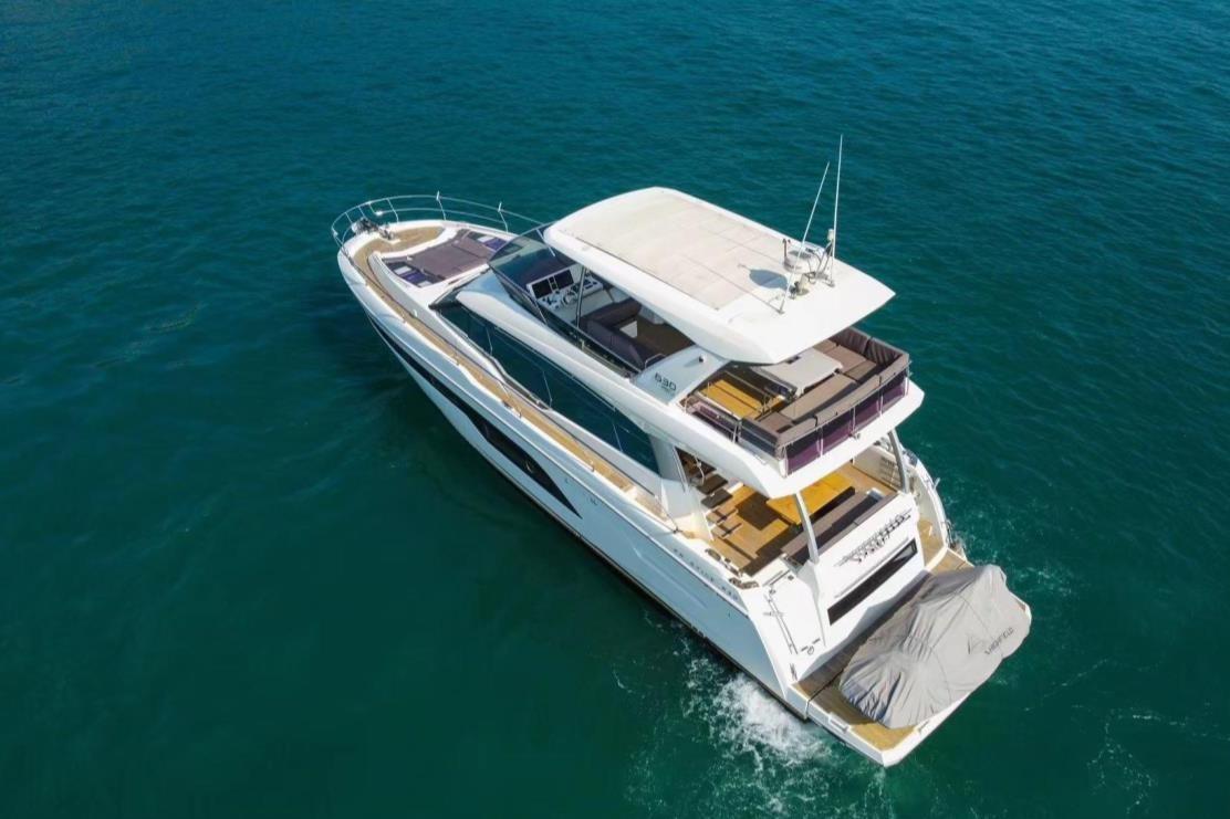 Luxurious 2019 Prestiage 630 yacht cruising on clear blue waters.