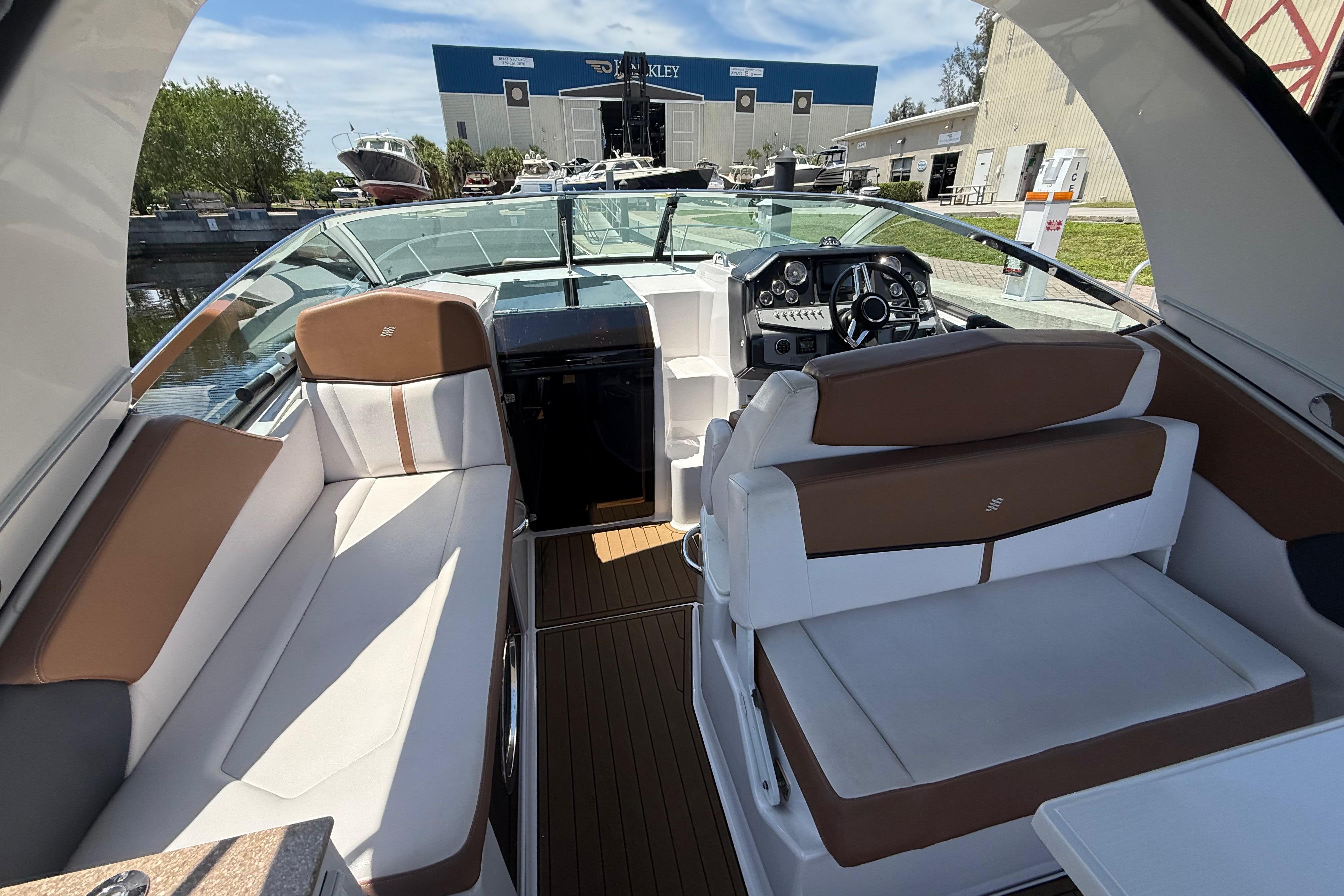 Interior of 2017 Four Winns V275 boat with brown and white seating.
