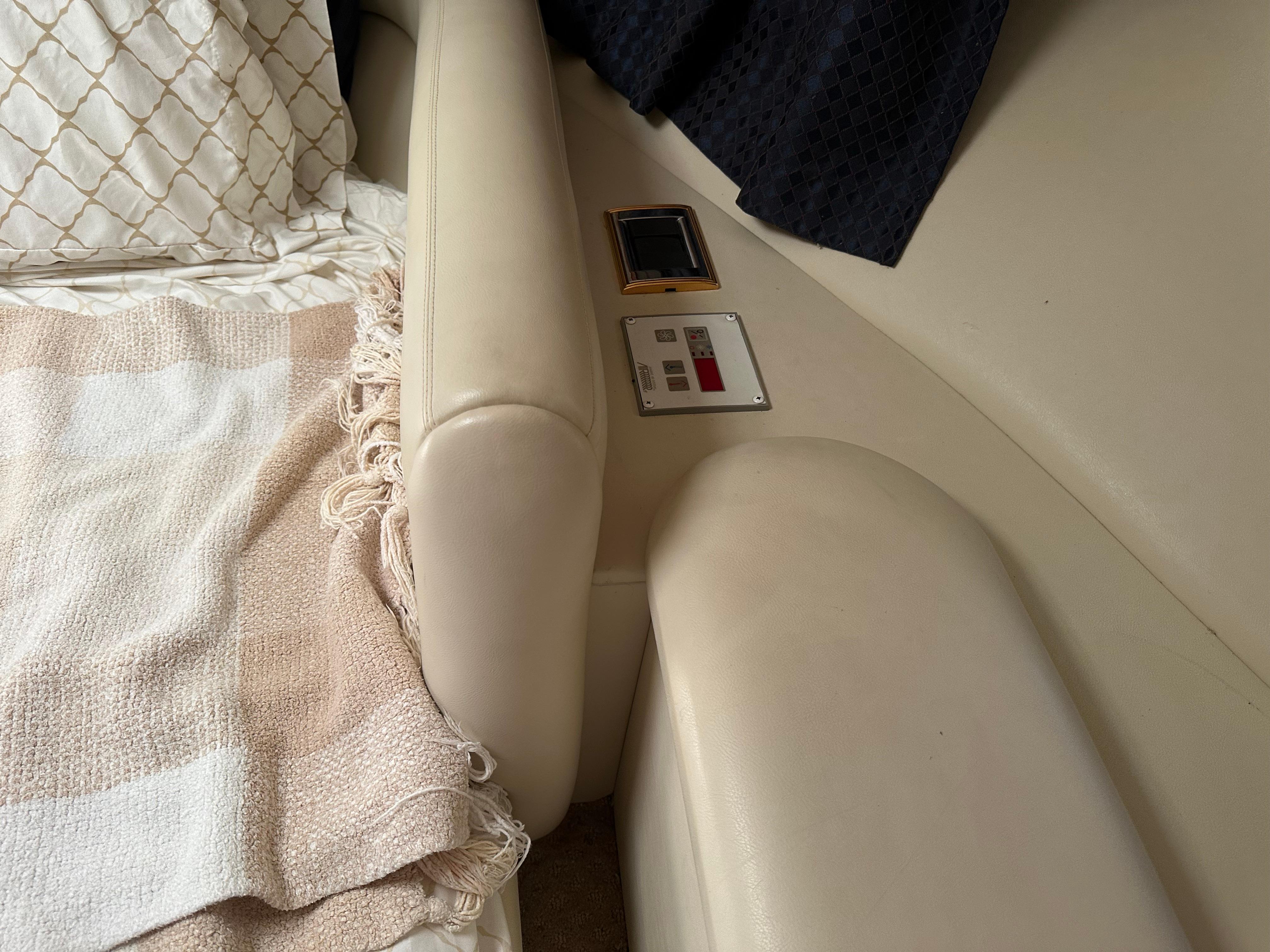 Interior of 1997 Sunseeker Camargue 47 yacht with beige seating and control panel.