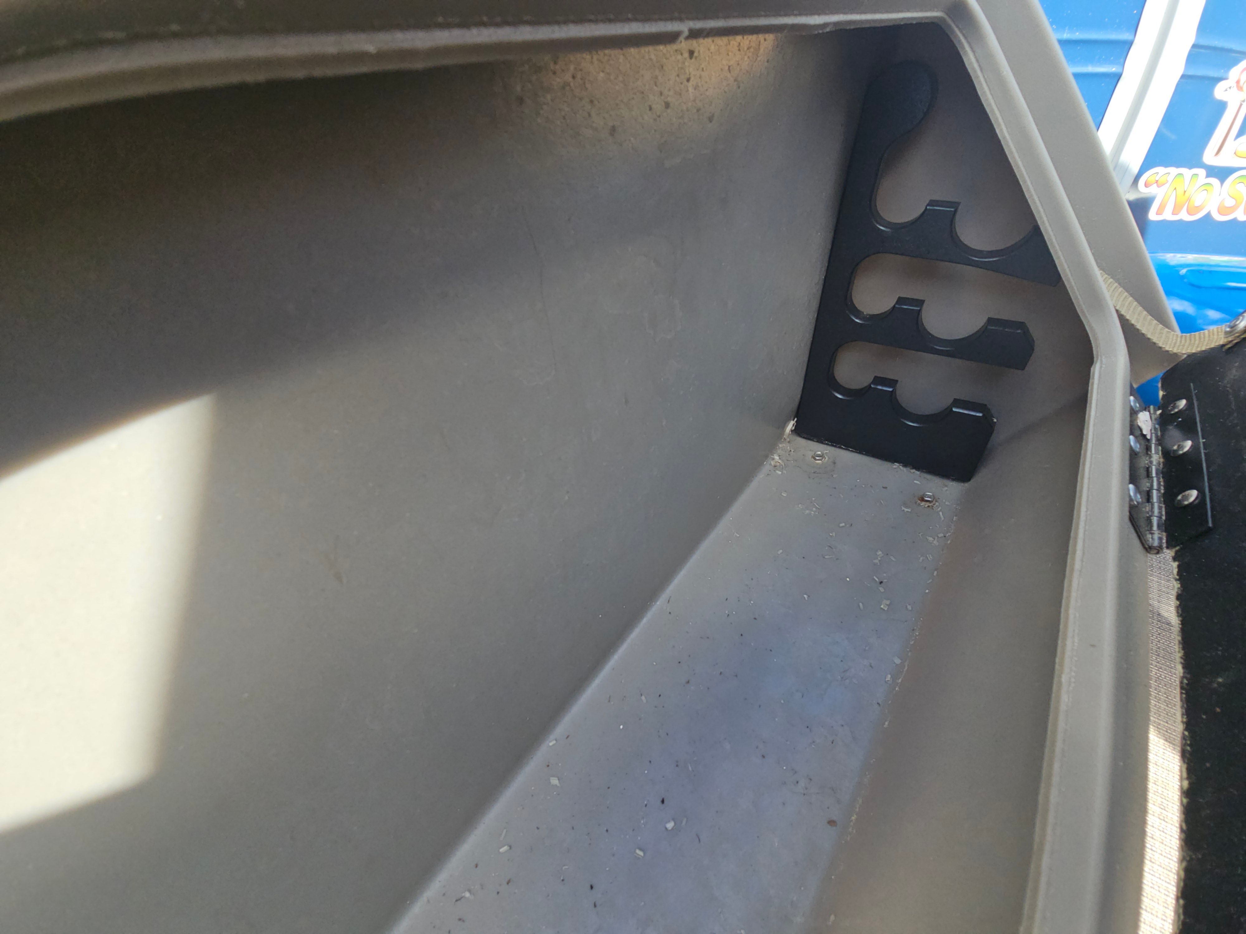 Interior view of 2024 Sun Tracker Fishin' Barge 22 DLX storage compartment.