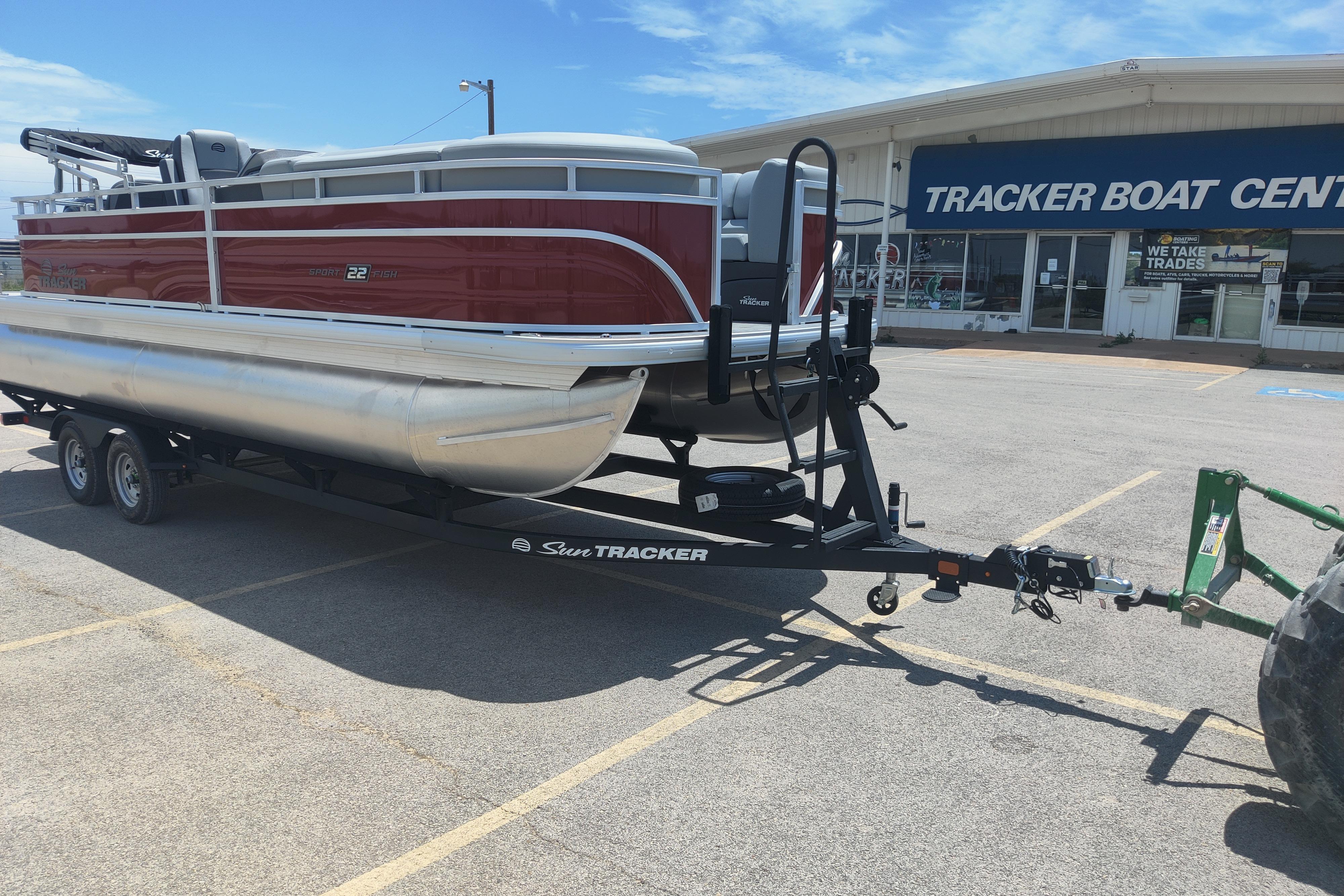 2026 Sun Tracker SportFish 22 DLX pontoon boat on trailer at Tracker Boat Center.