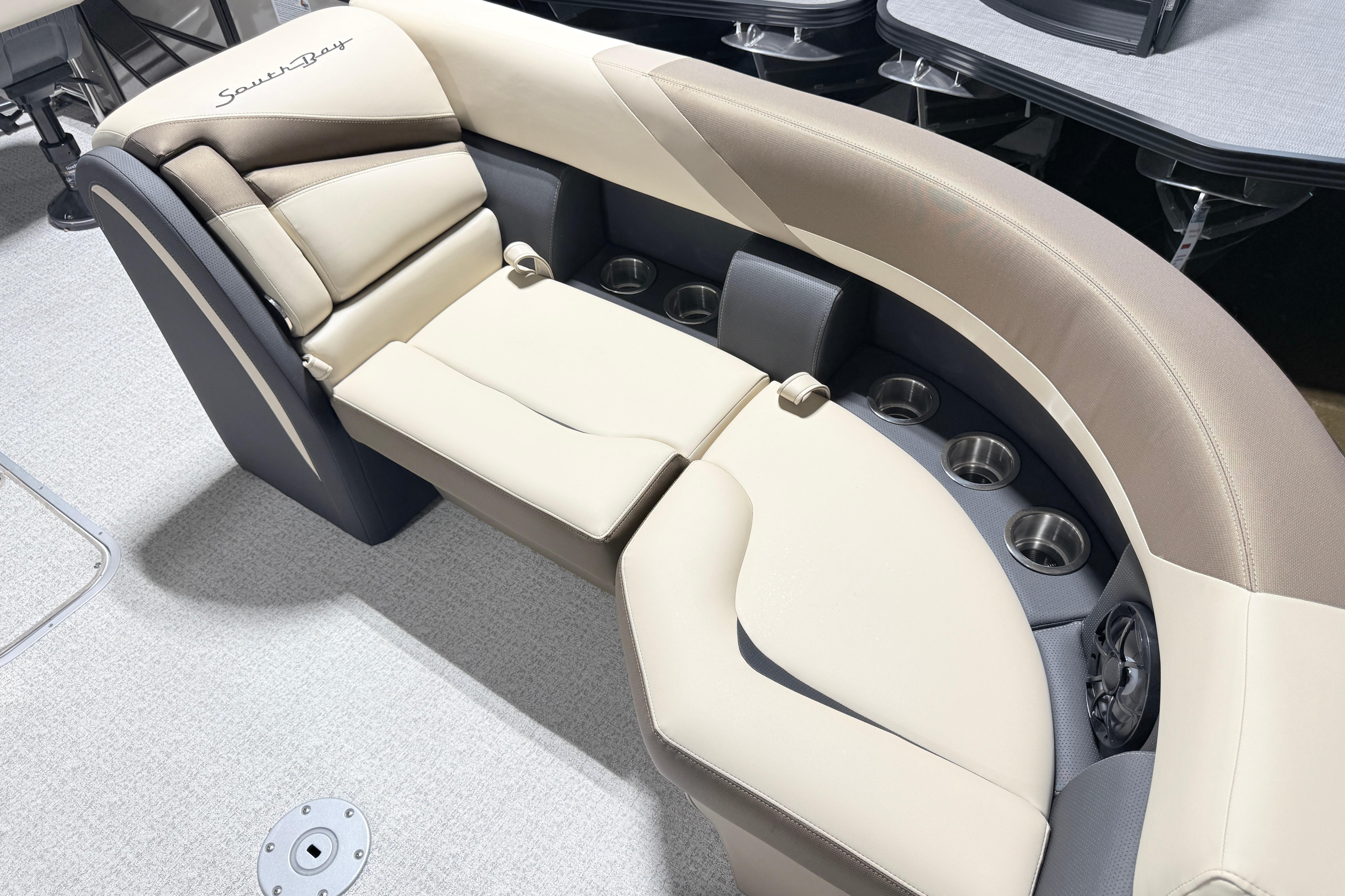 Luxurious seating on 2026 South Bay S224E pontoon boat with cup holders and plush cushions.